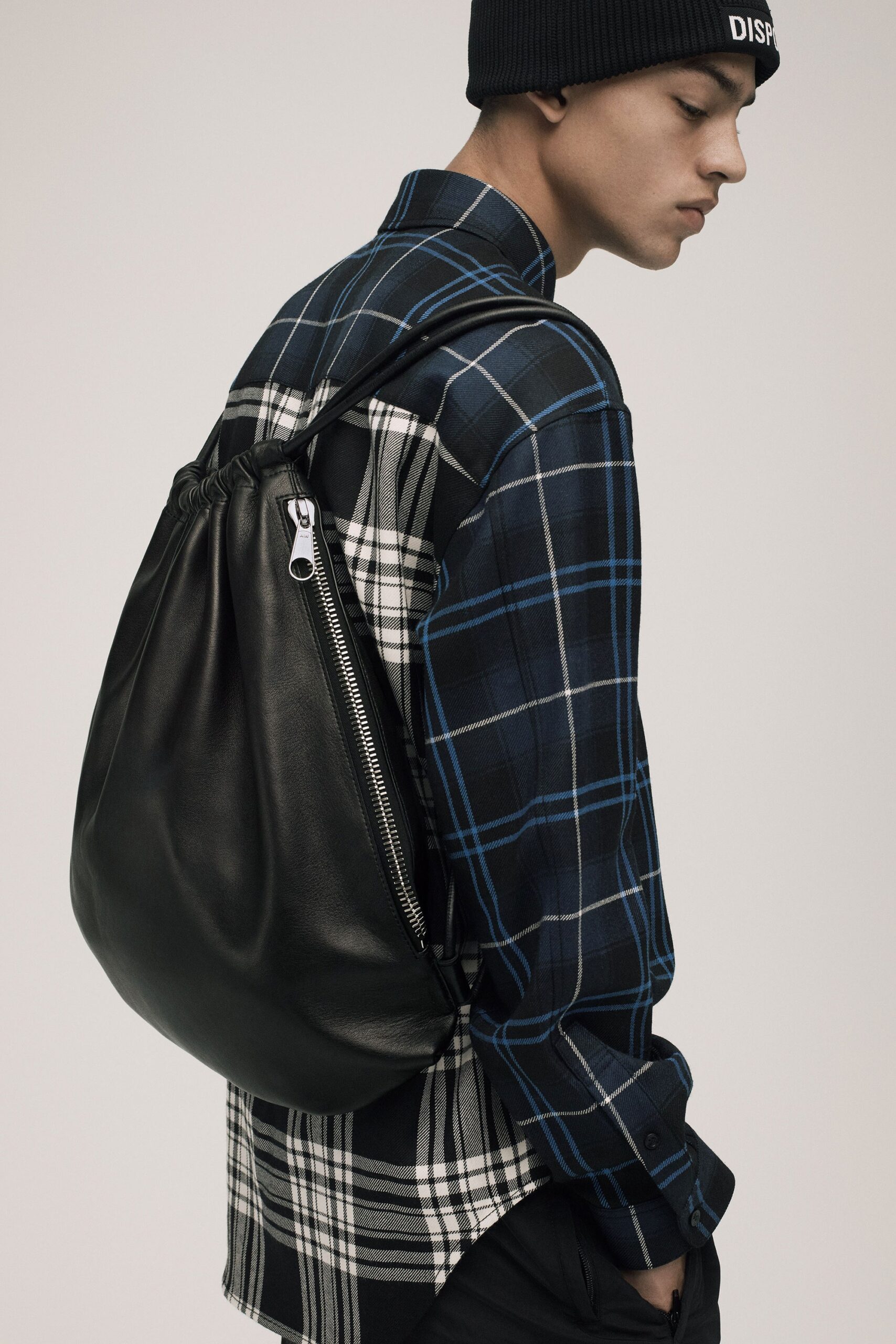 checked shirt and leather bag