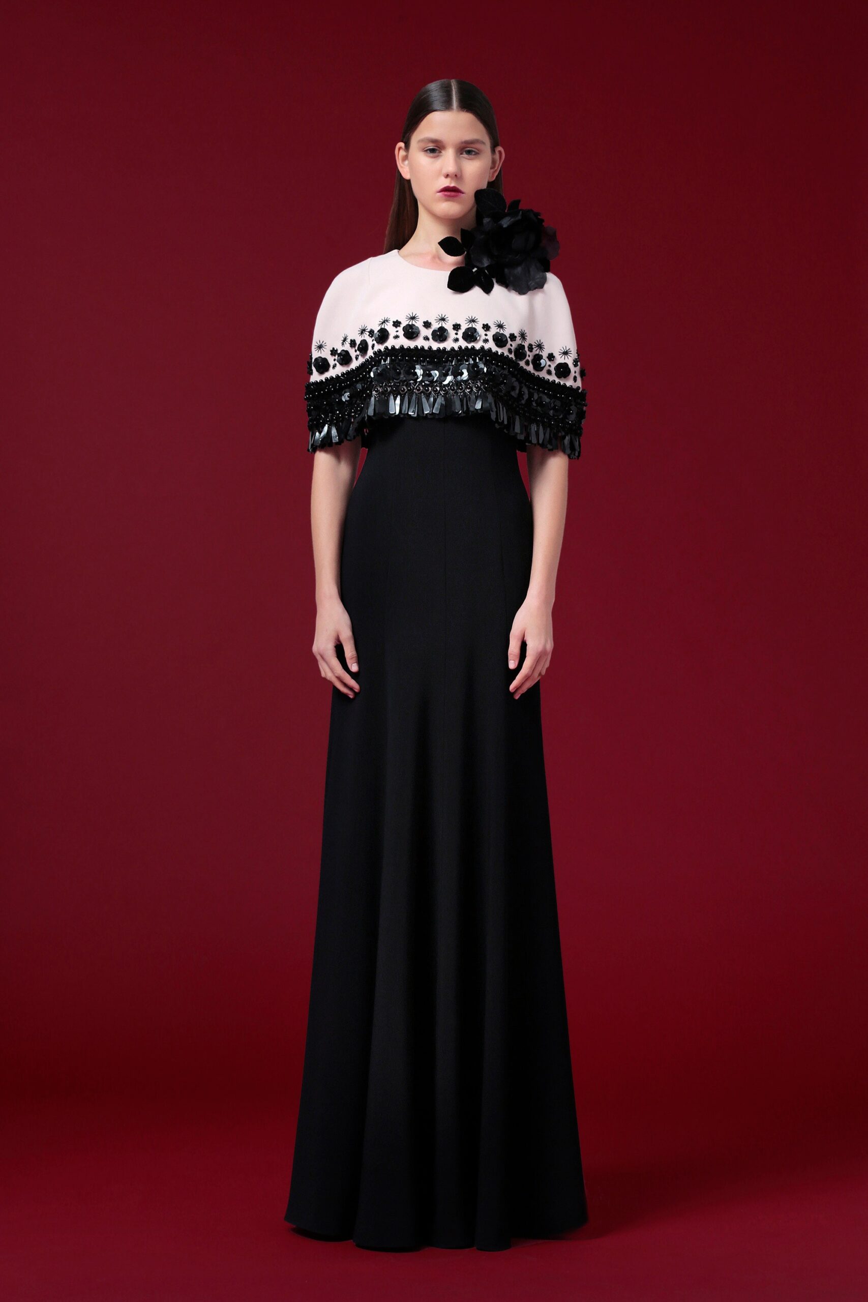 black silk fitted gown with white cape