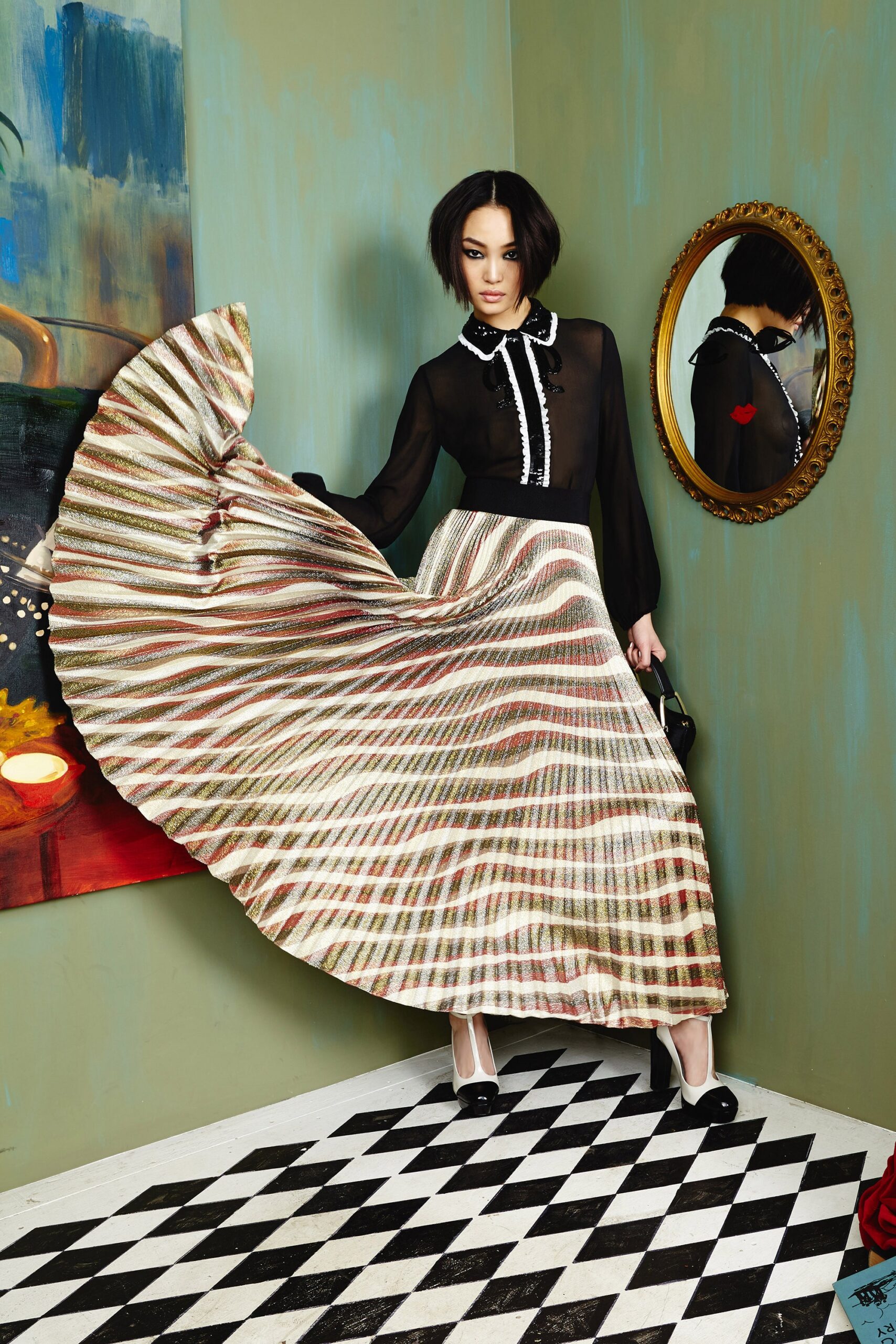 black silk blouse and pleated skirt