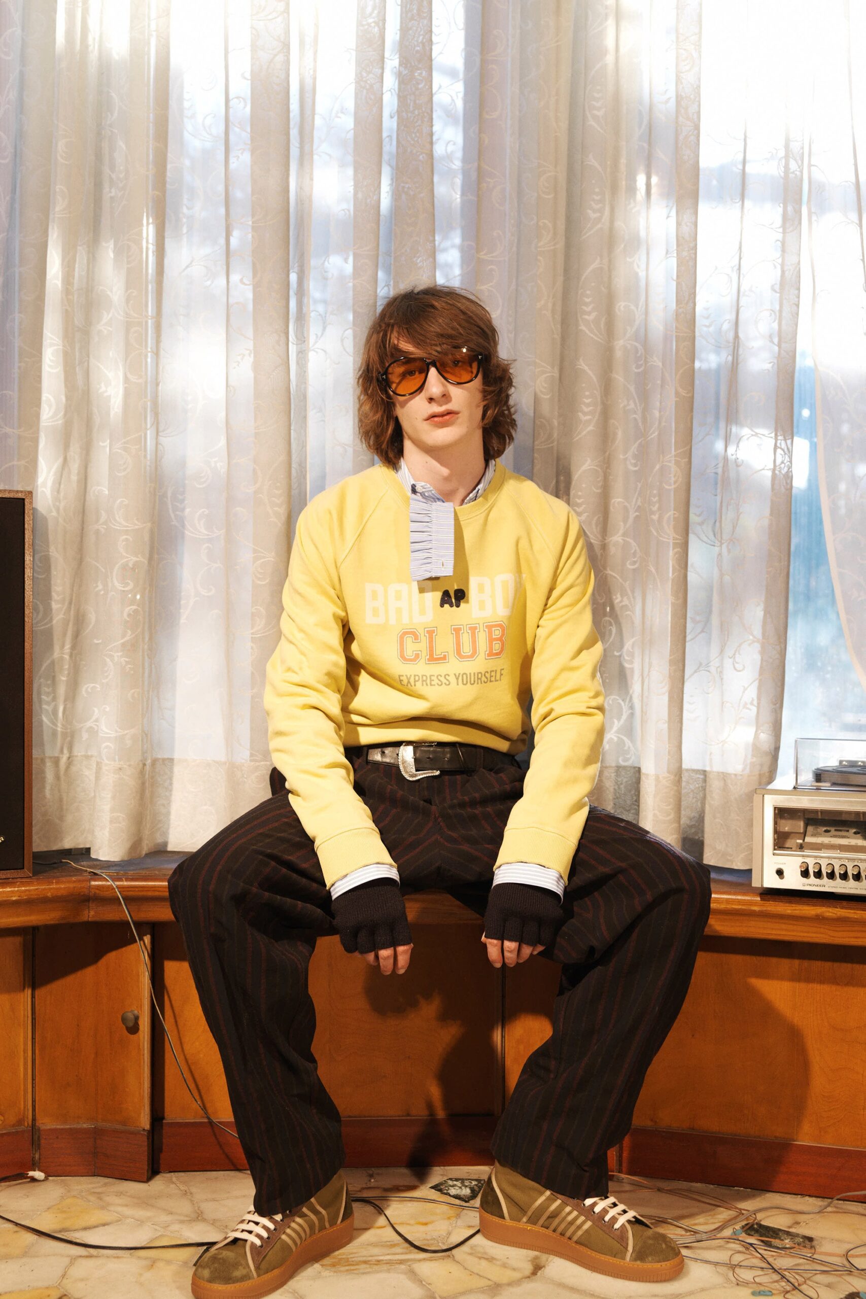 yellow relaxed sweater with striped pants