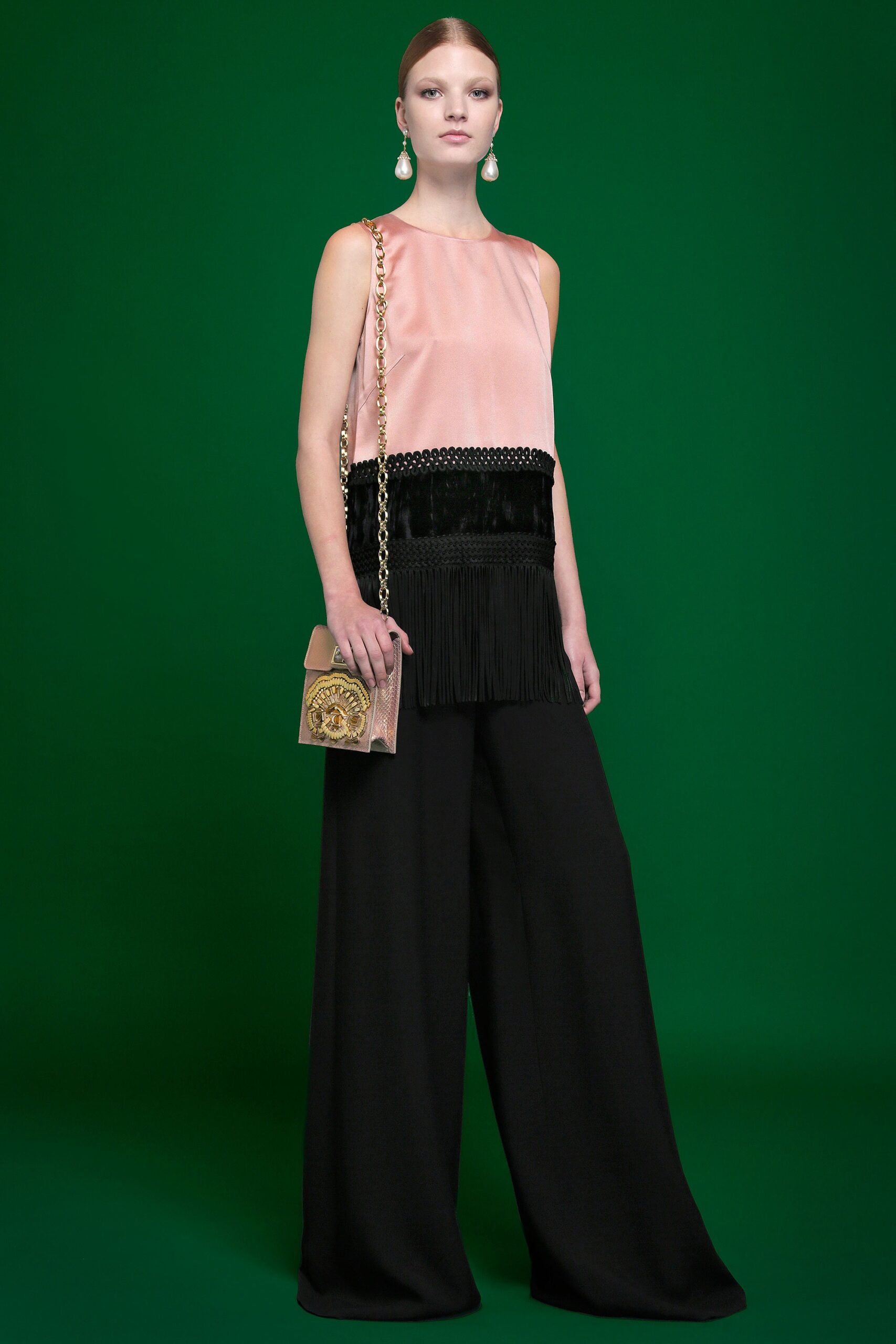 pink silk sleeveless top and black wide-leg pants