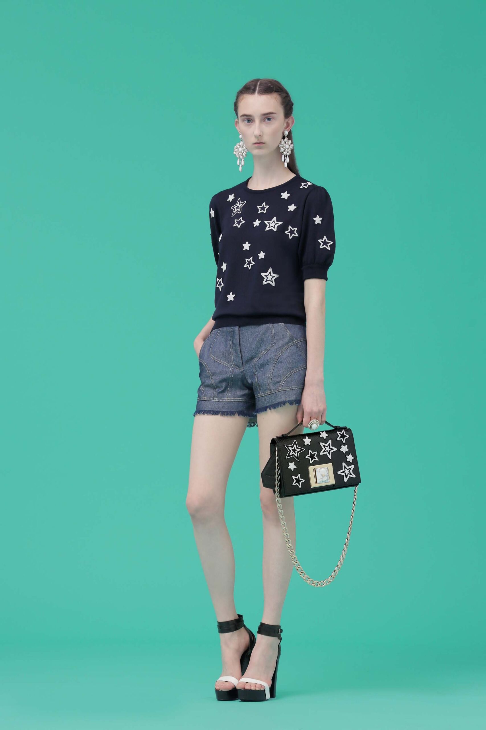 black star-printed top with denim shorts