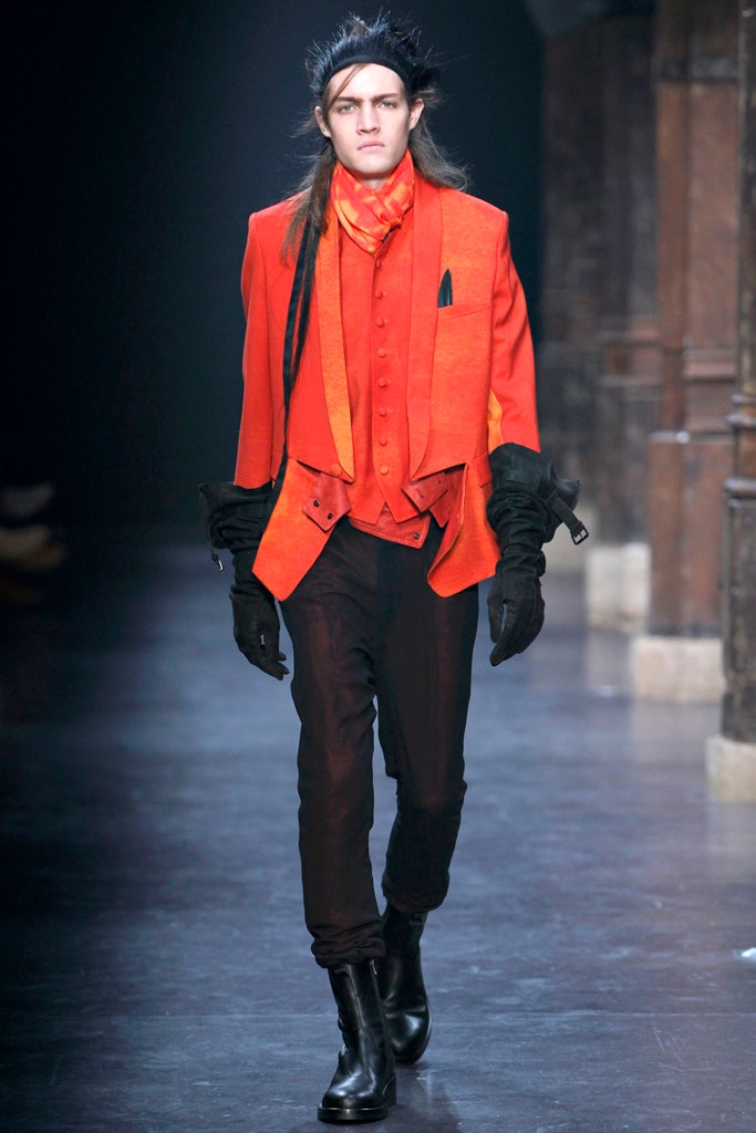 orange tailored blazer and black pants