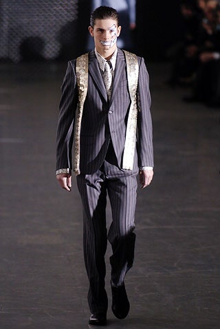 tailored black suit with gold vest