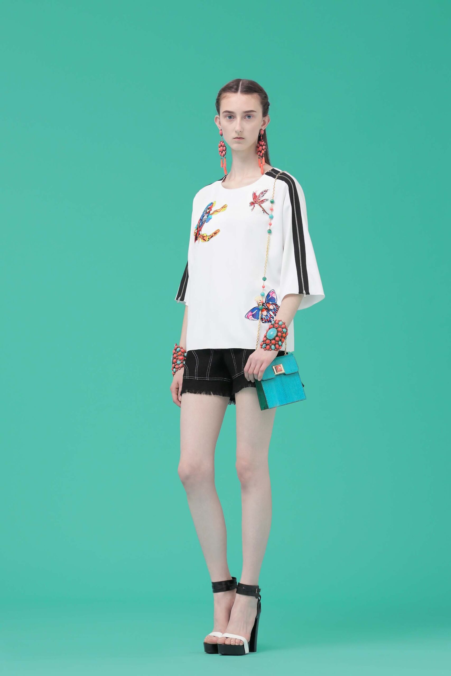 white relaxed top with black shorts