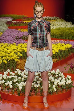 multi-colored checked shirt with blue pleated skirt