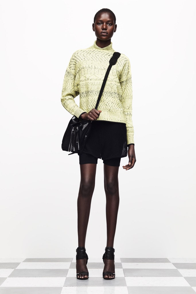 yellow knit turtleneck sweater with black shorts