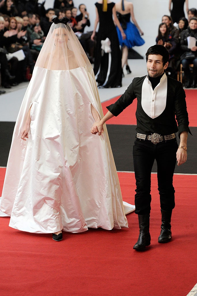 white silk sleeveless high-neck fitted draped flowing gown