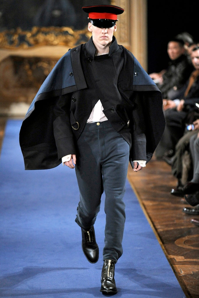 black wool cape and tailored pants