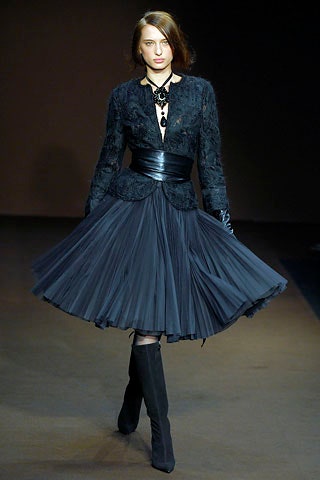 black silk blouse and pleated skirt