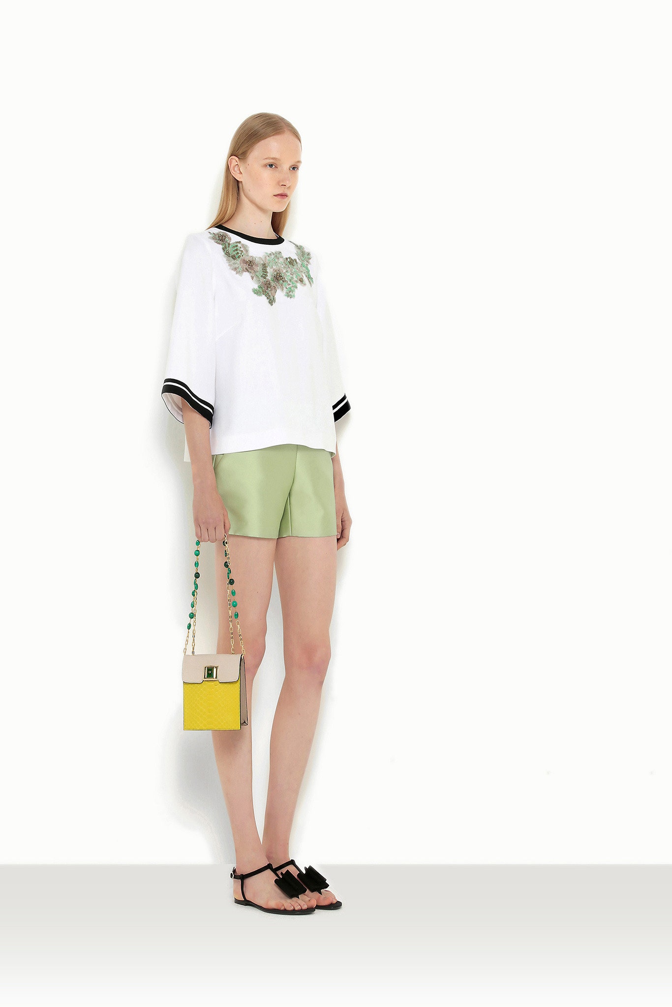 white embroidered top with green shorts