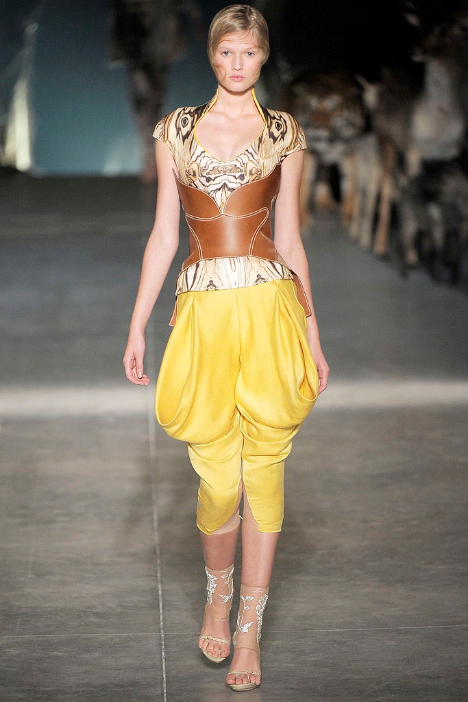 brown leather corset with yellow pants