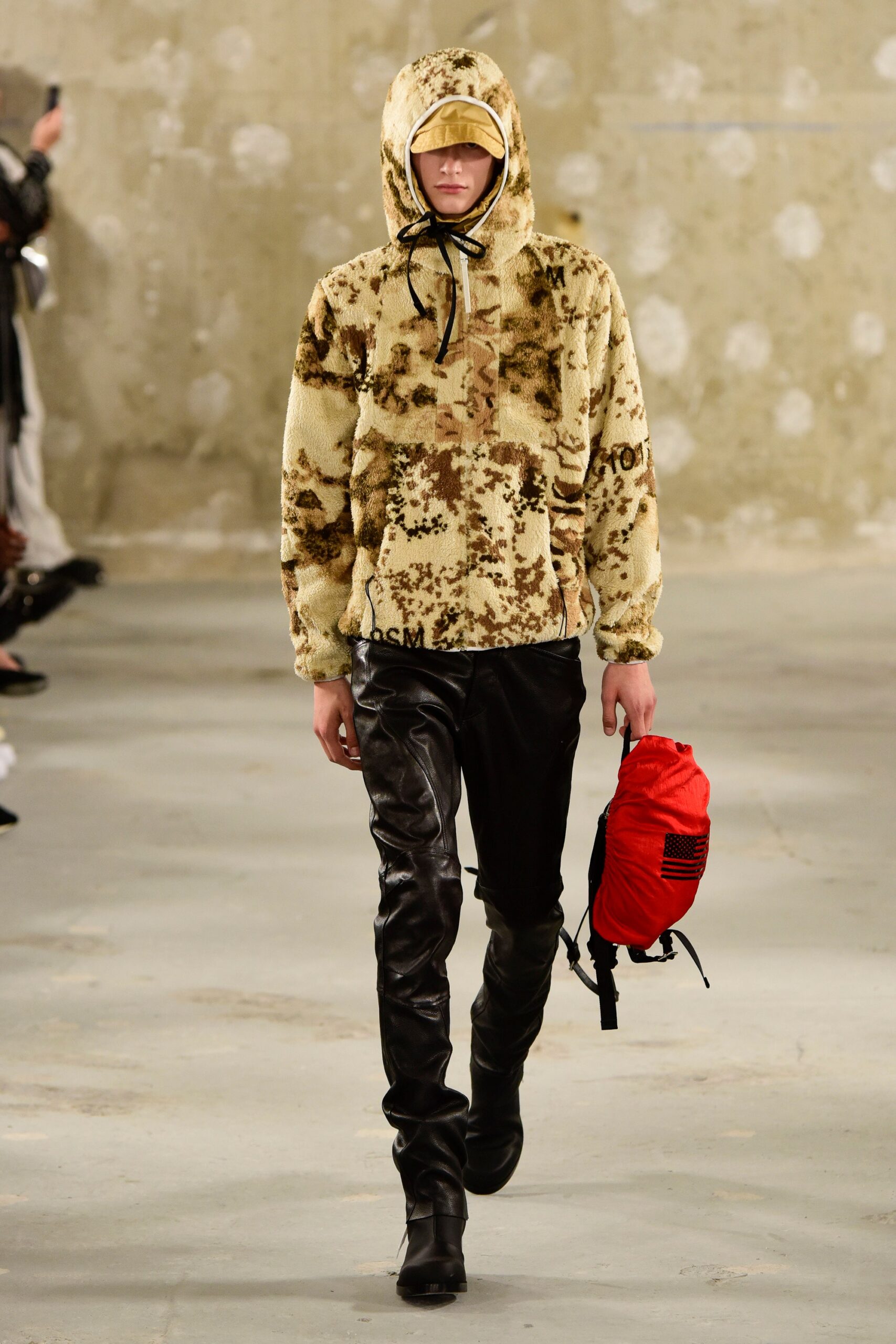 beige faux-fur hoodie with black pants