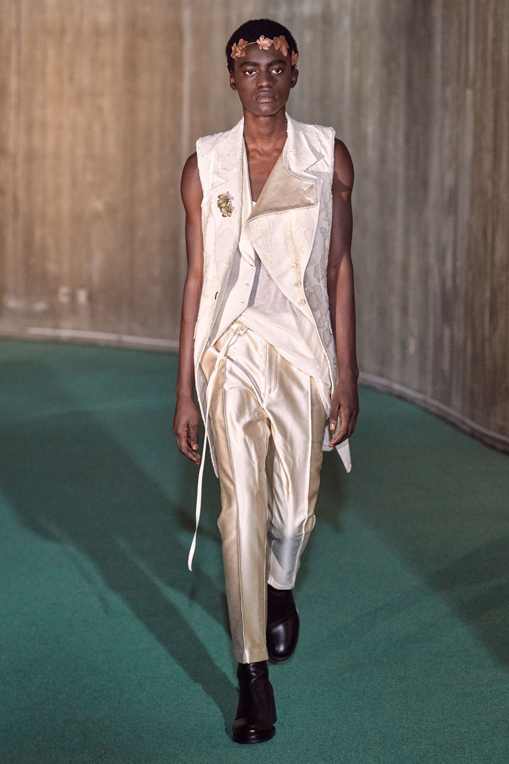 white fitted vest and beige tailored pants