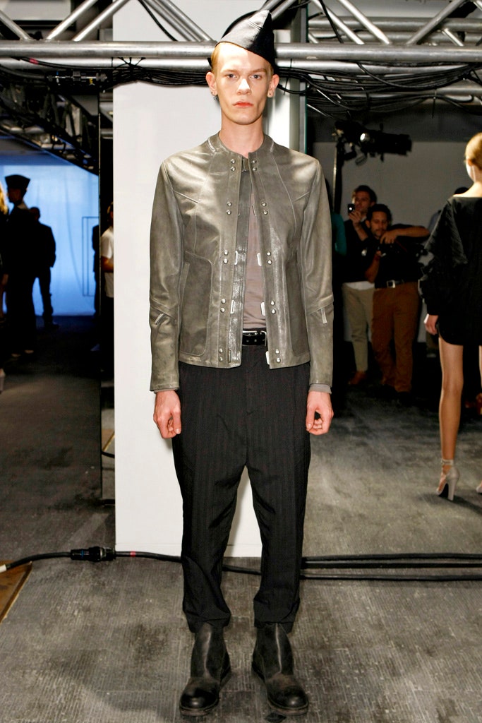 gray leather jacket with black pants