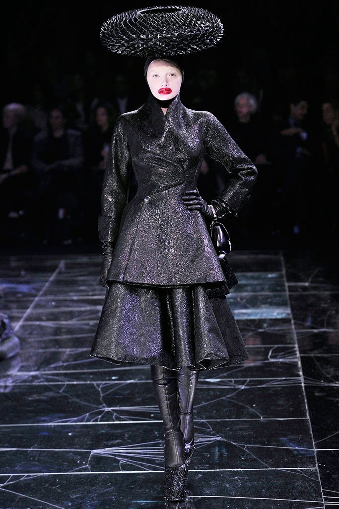 black silk fitted midi dress with structured hat