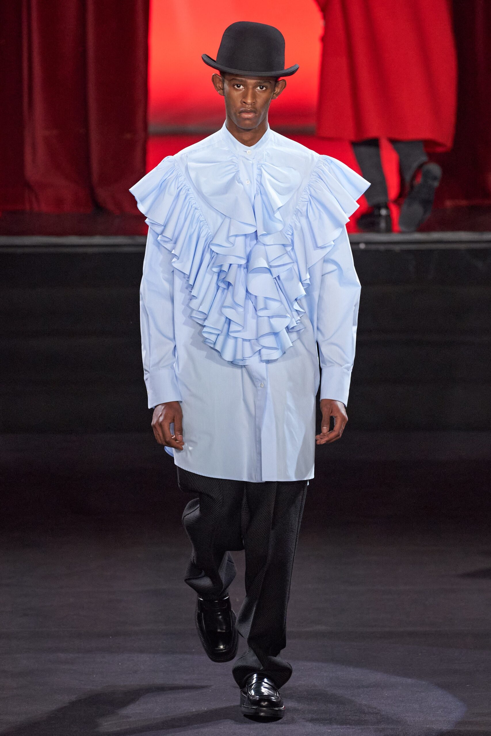 light blue ruffled shirt with black pants