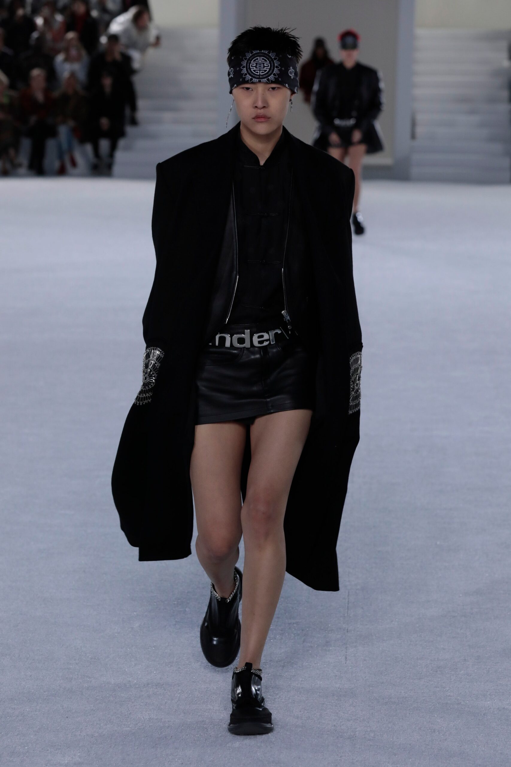black oversized coat and leather shorts