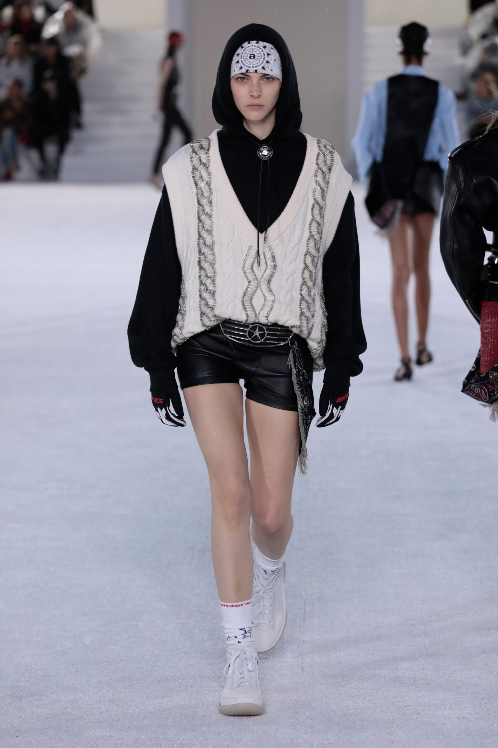 oversized white knit sweater with black leather shorts