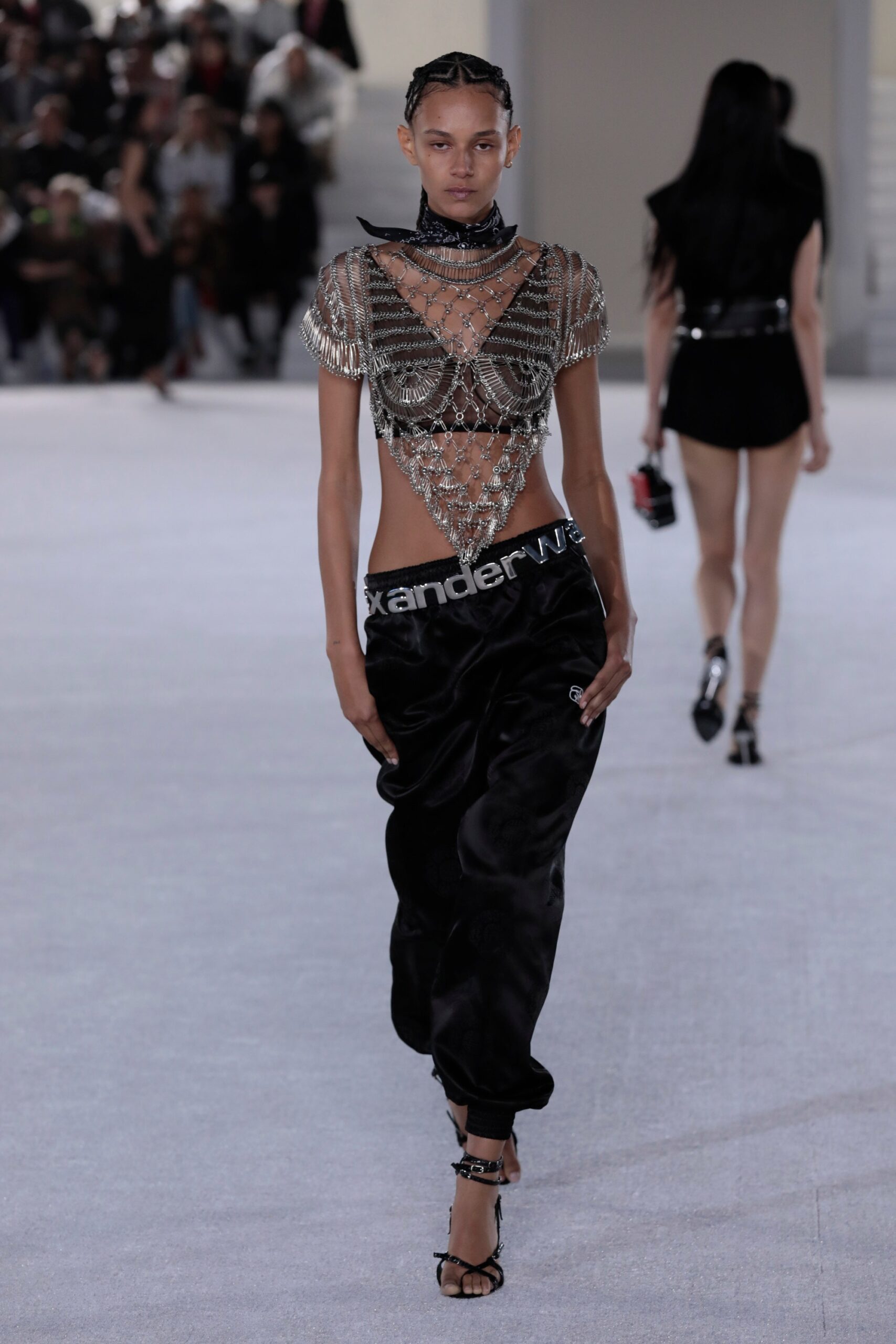 silver beaded sleeveless top with black pants