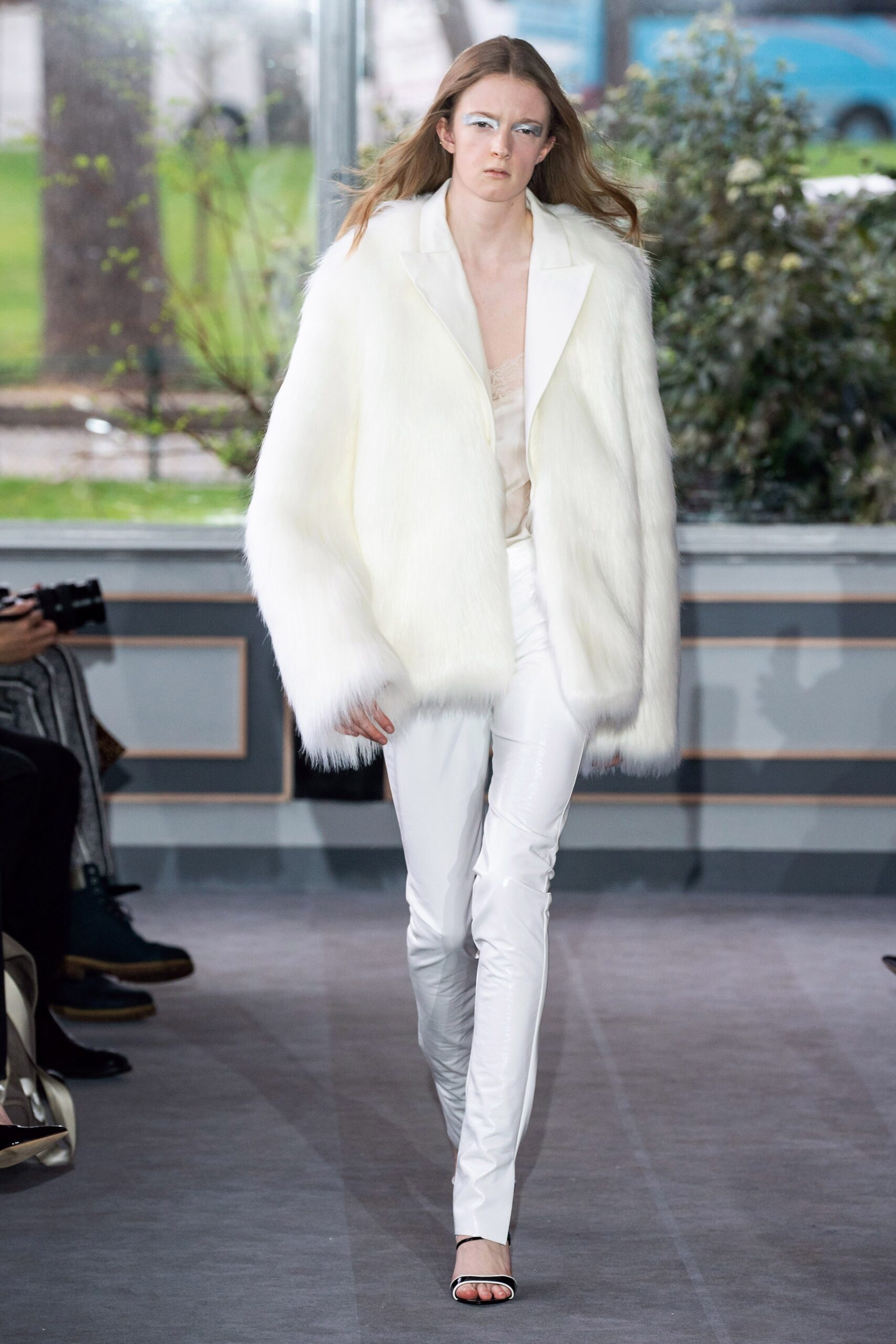 white faux-fur coat and silk pants