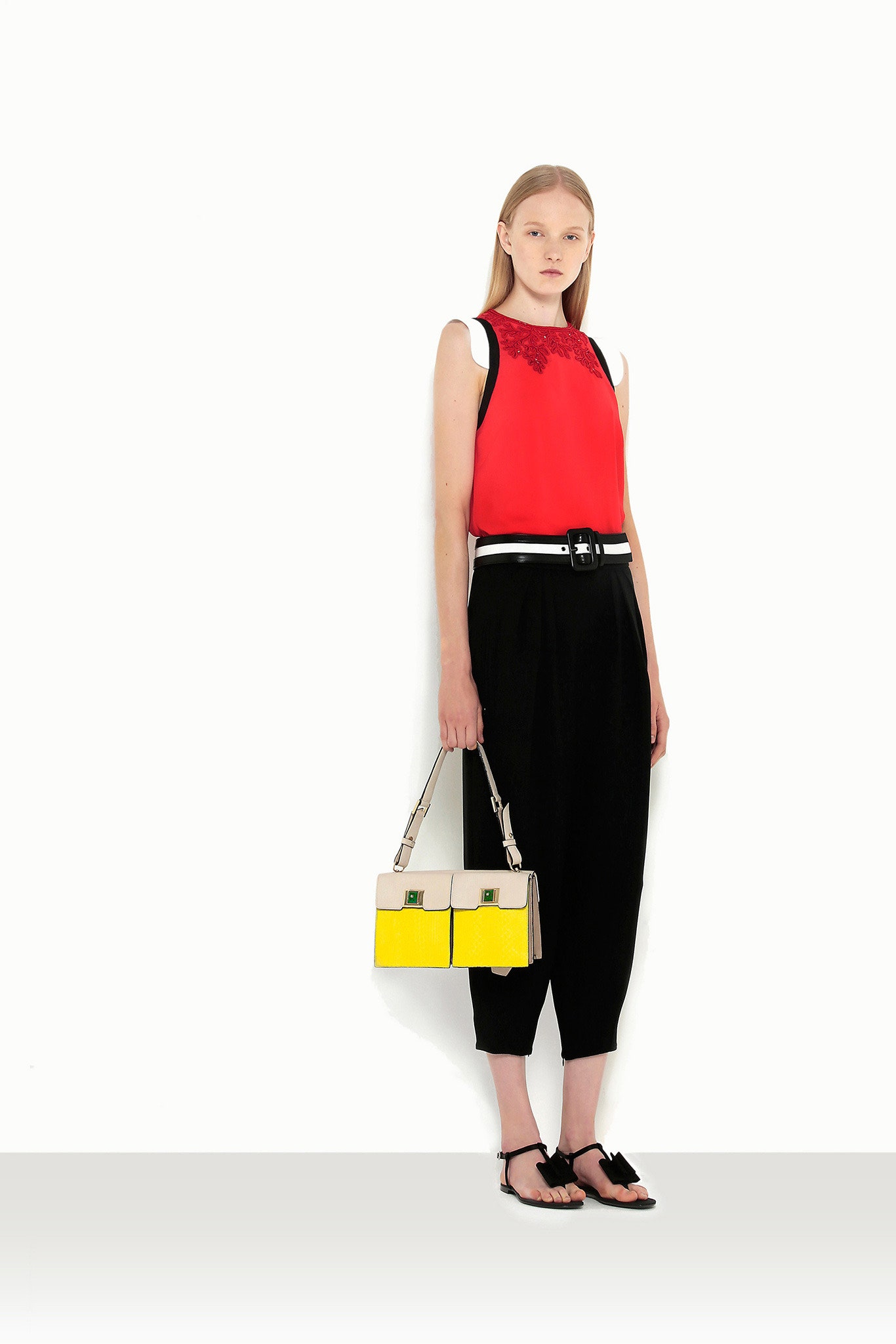 red sleeveless top with black pants