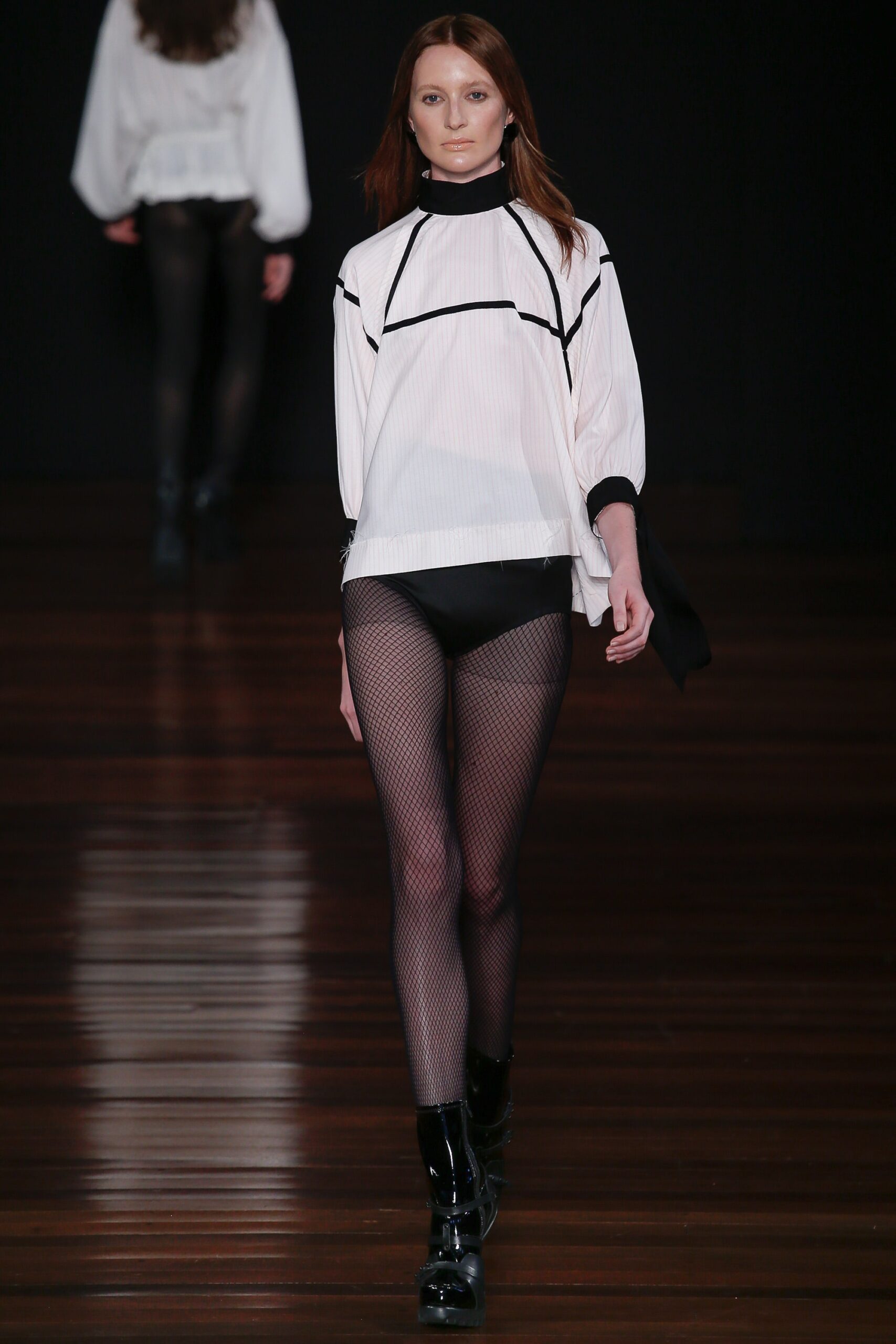 white relaxed top with black shorts