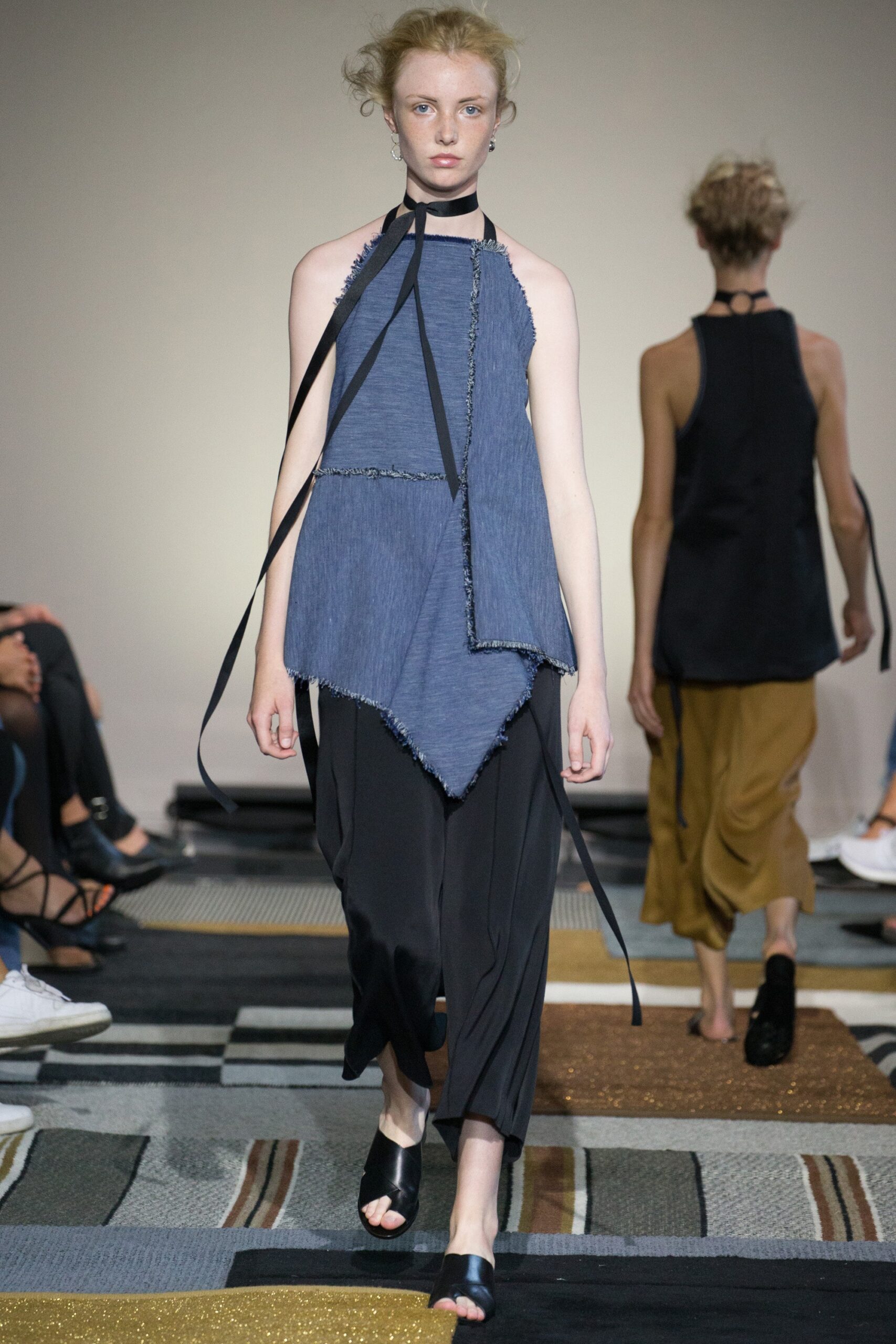 blue asymmetric top with black pants