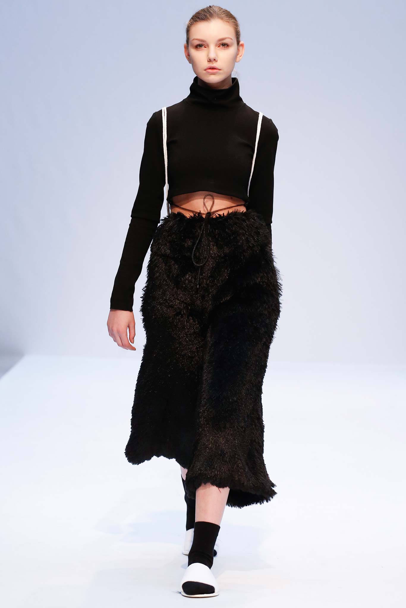 black cropped top and faux-fur skirt