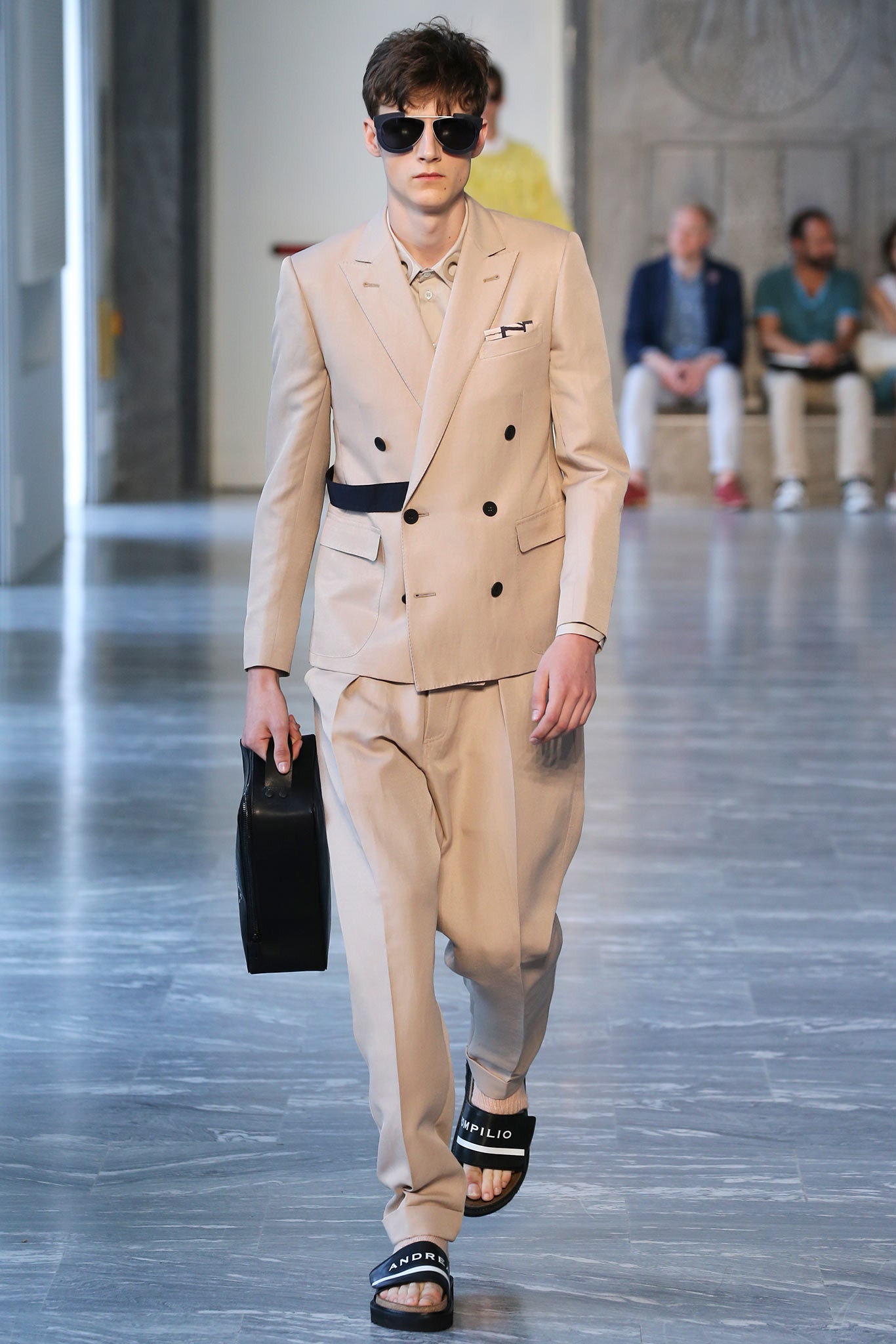 beige tailored suit with black accessories