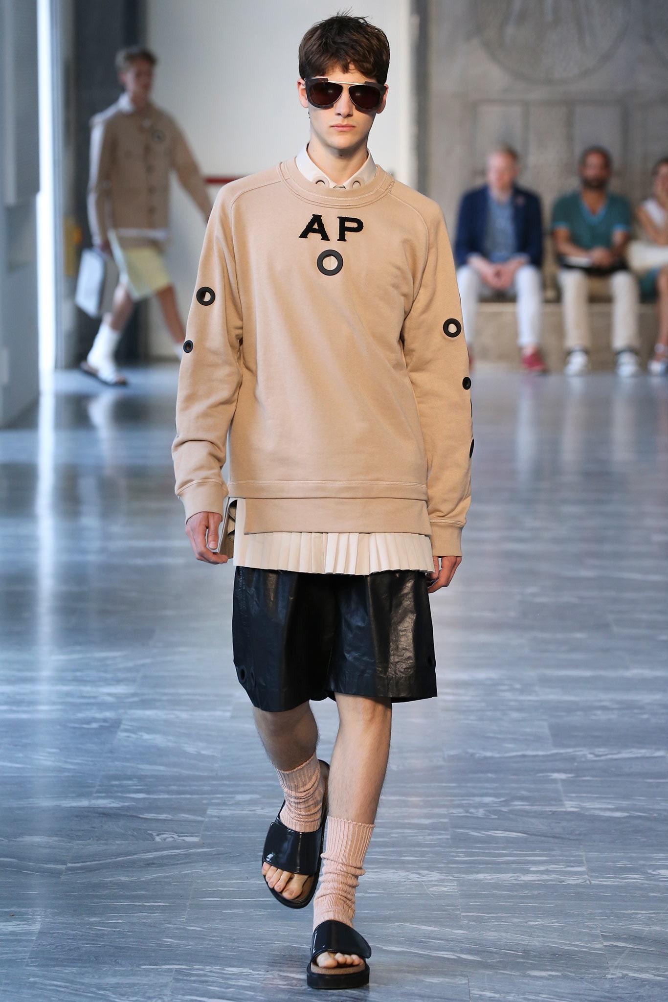 beige relaxed sweater with black shorts