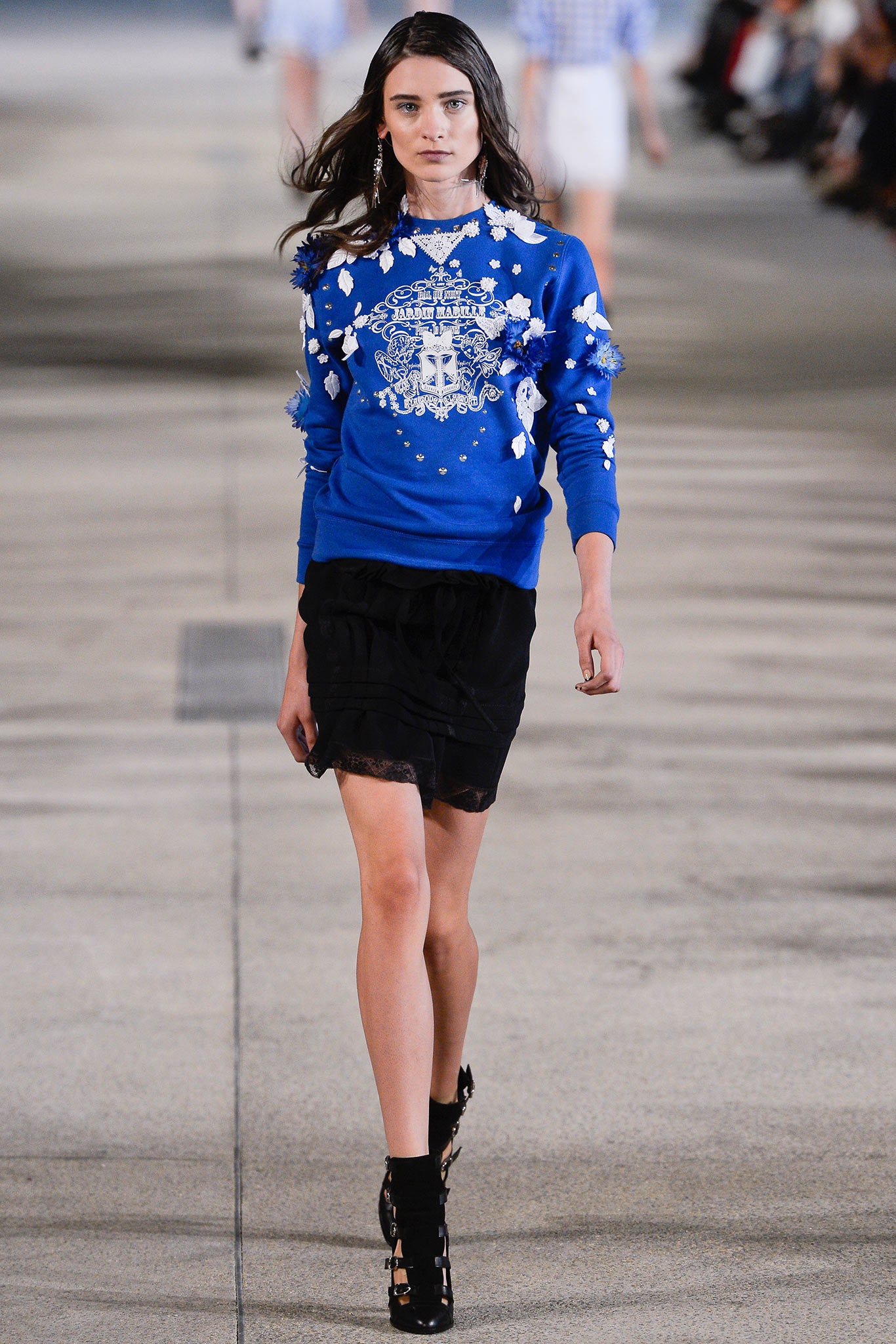blue embroidered sweater and black skirt