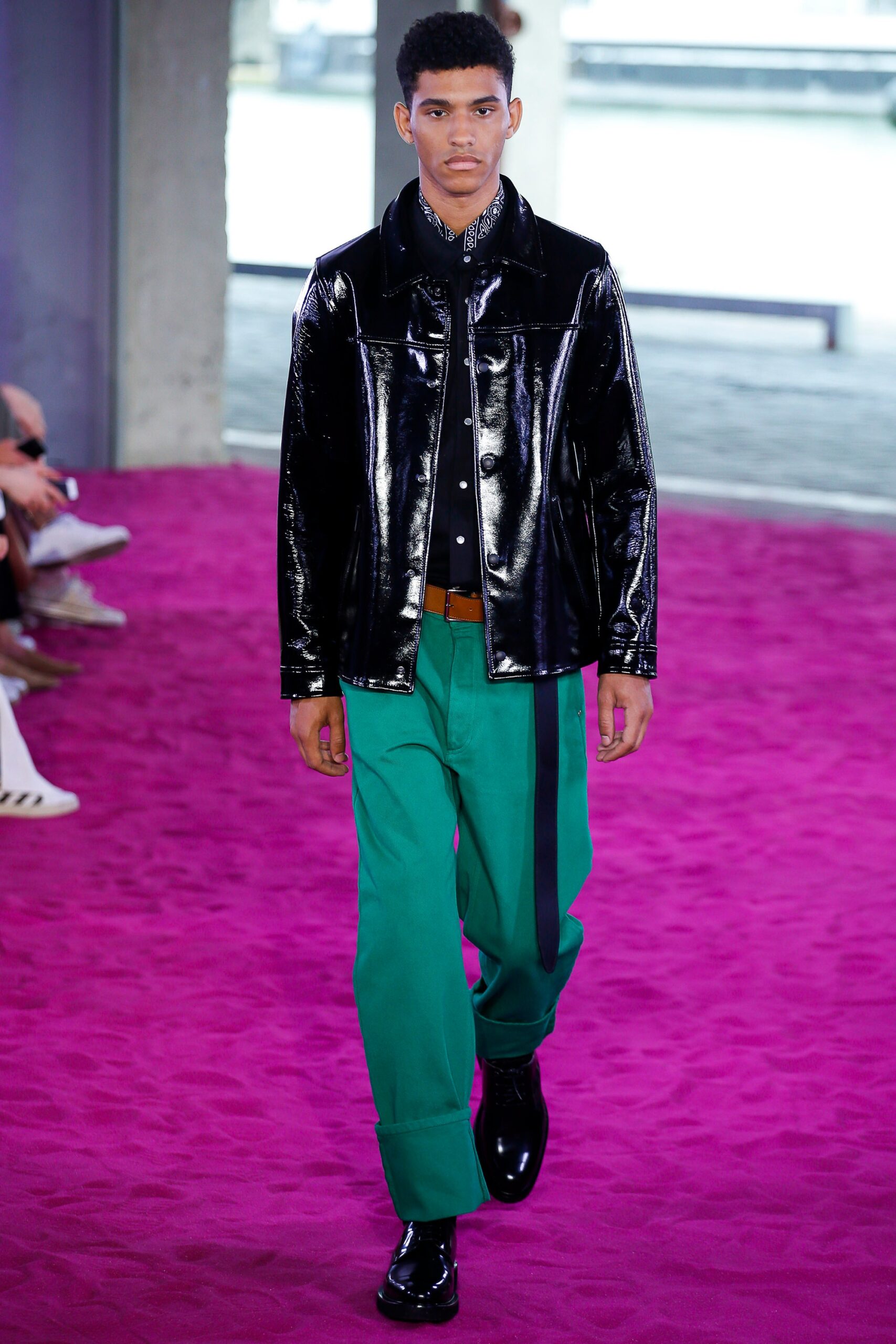 black vinyl jacket and green pants