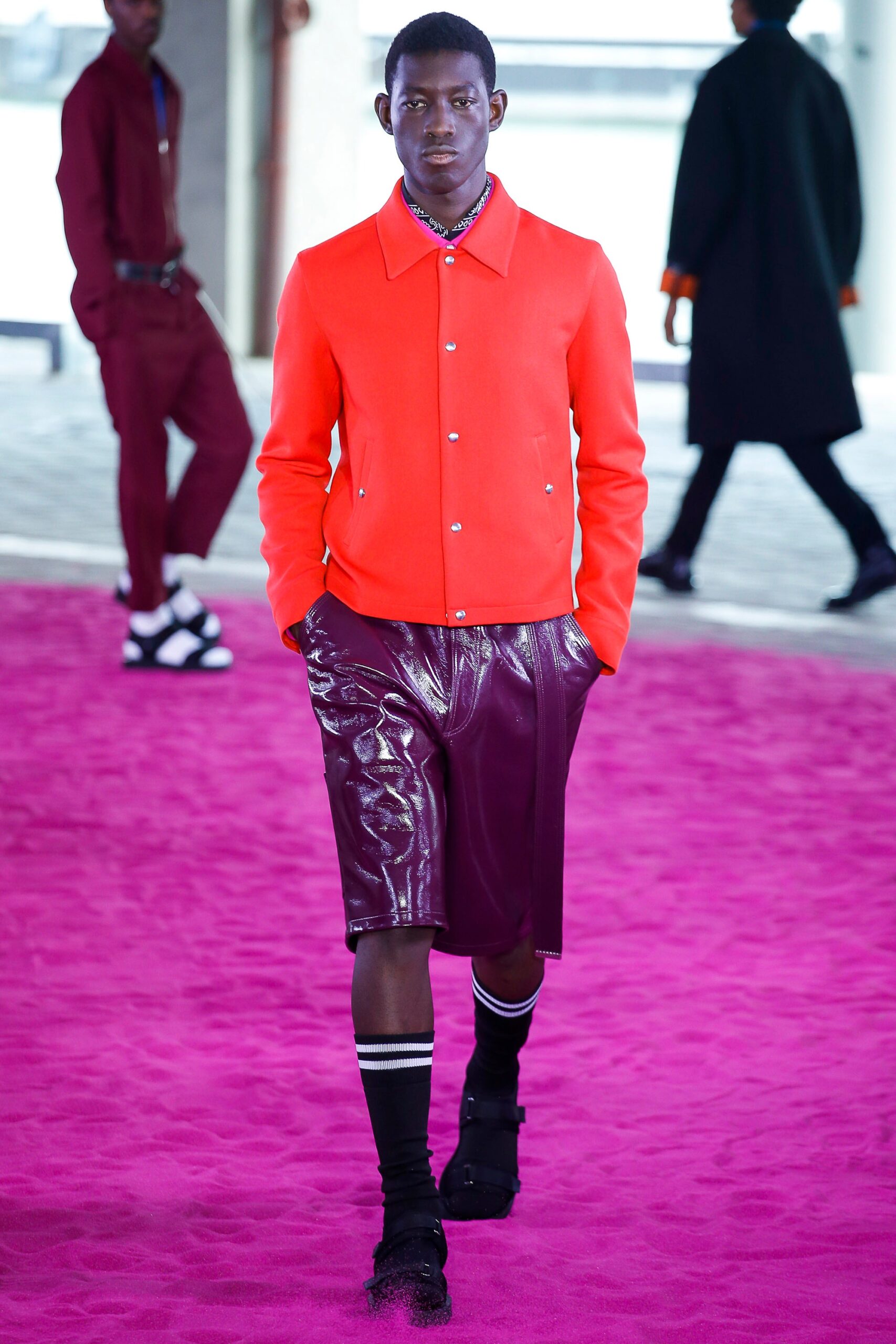 red fitted jacket and purple shorts