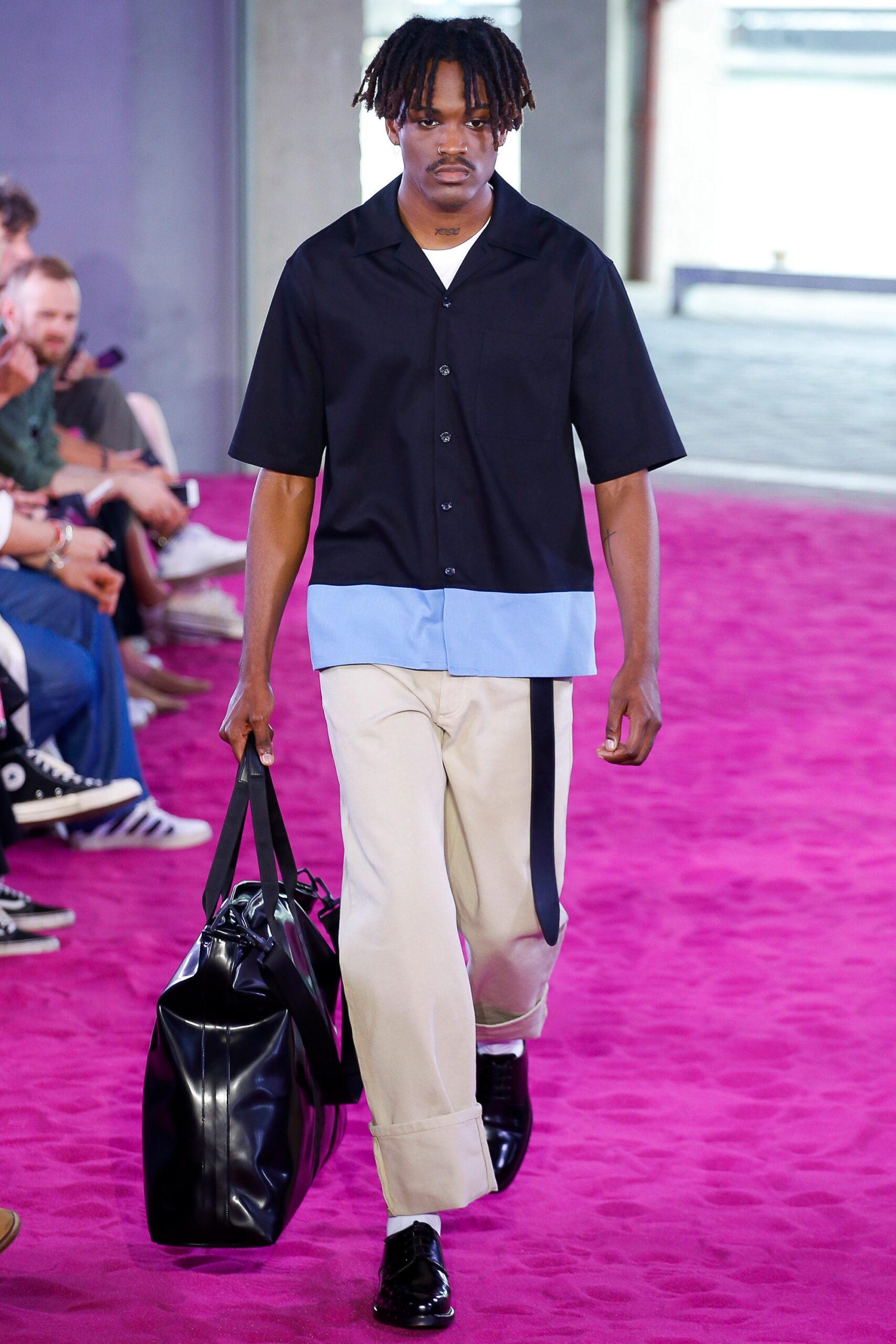black and blue relaxed shirt with beige pants