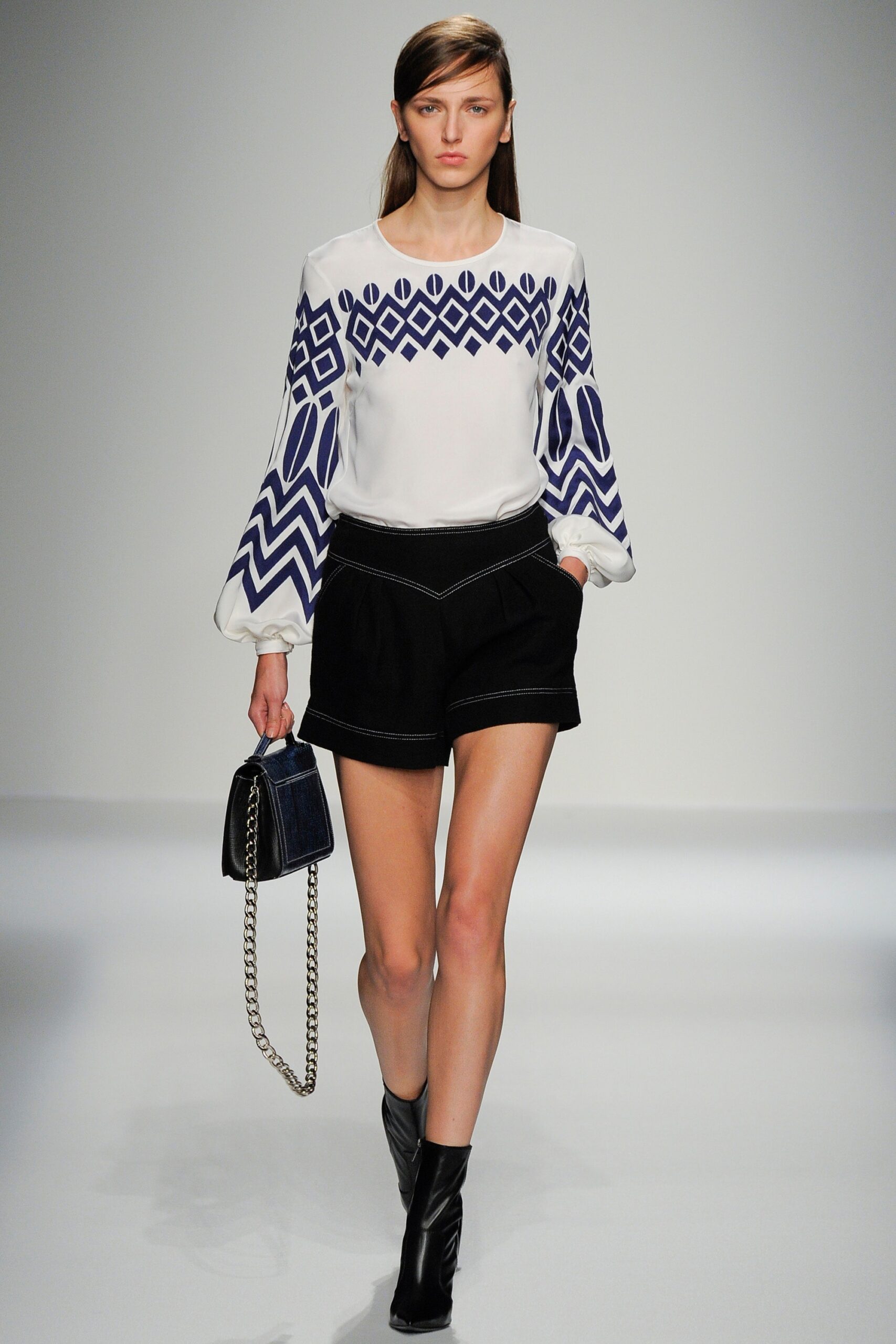 white embroidered blouse with black shorts