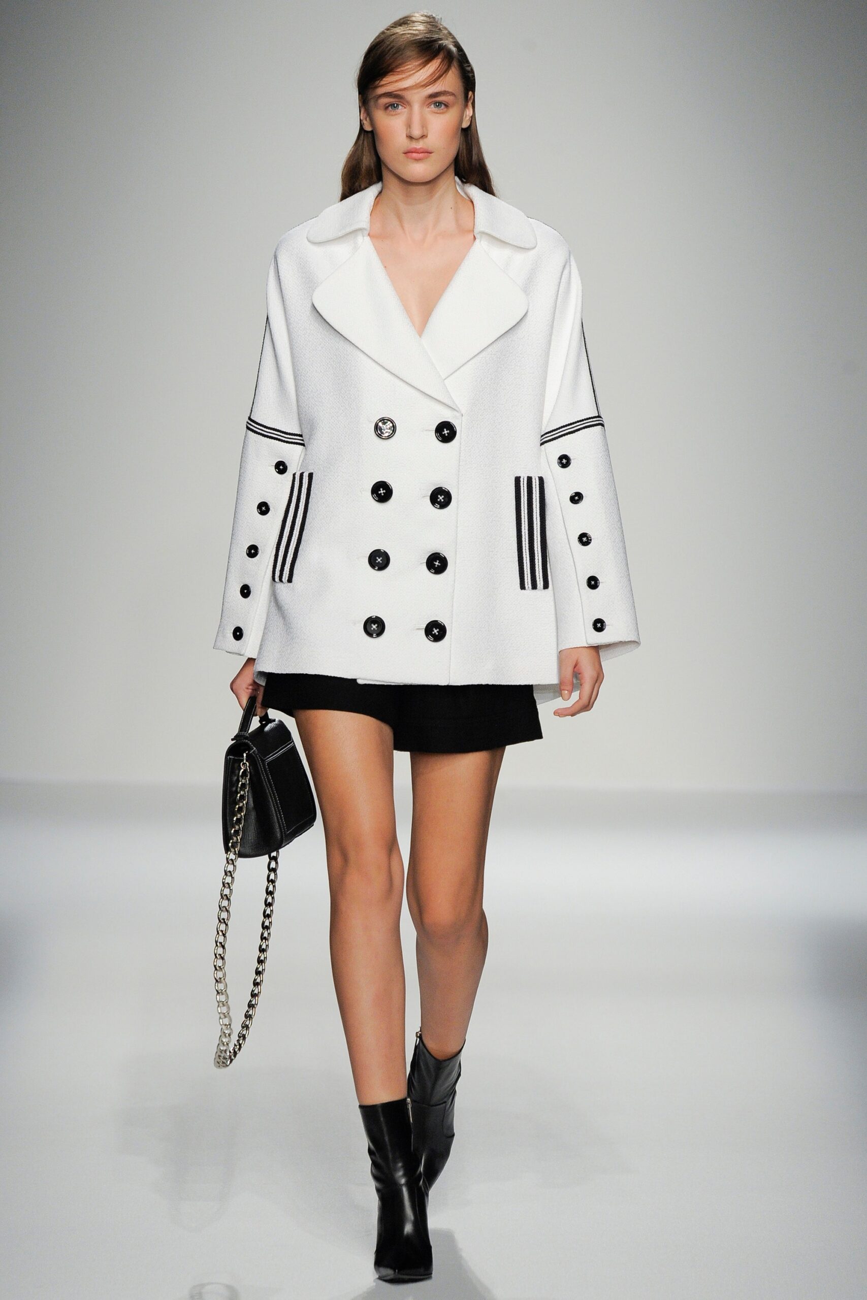 white double-breasted coat with black skirt