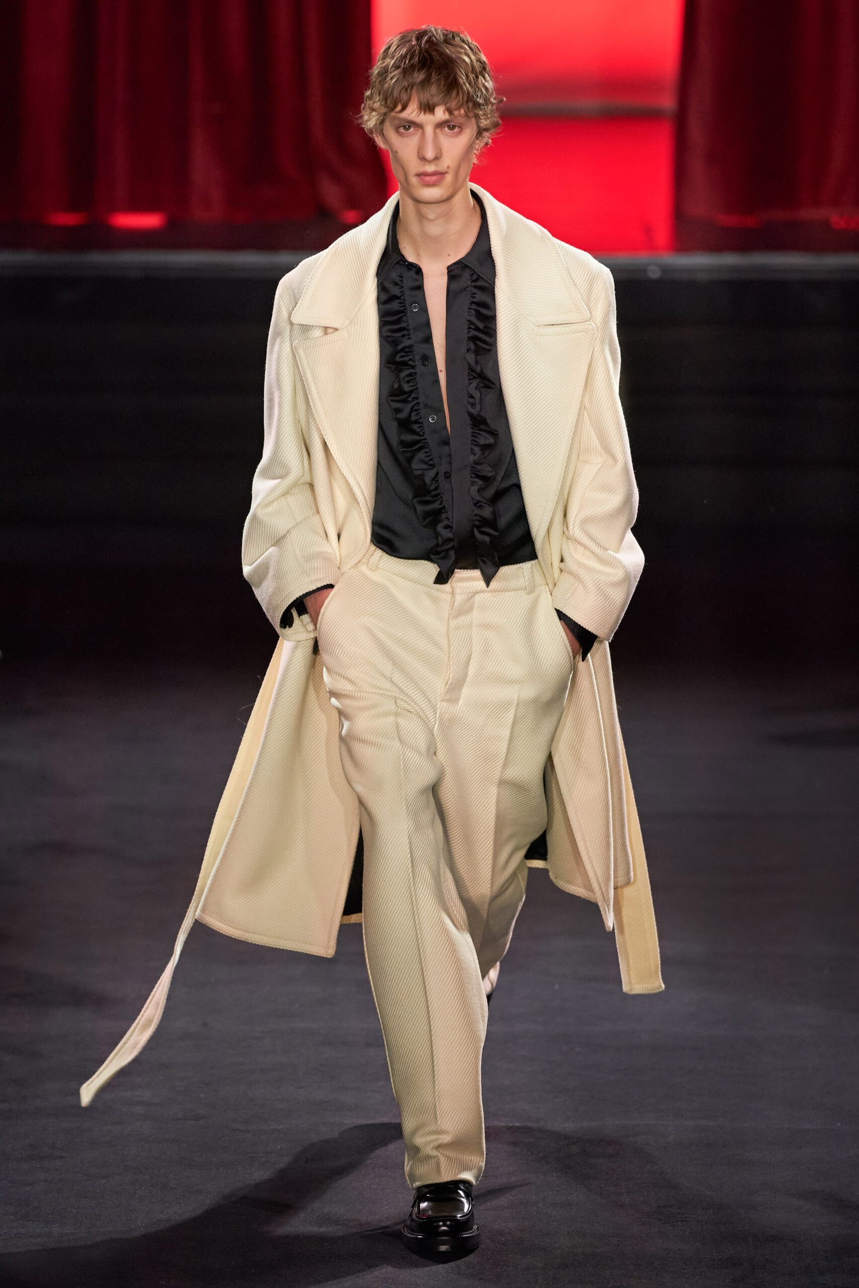 beige coat black shirt white pants