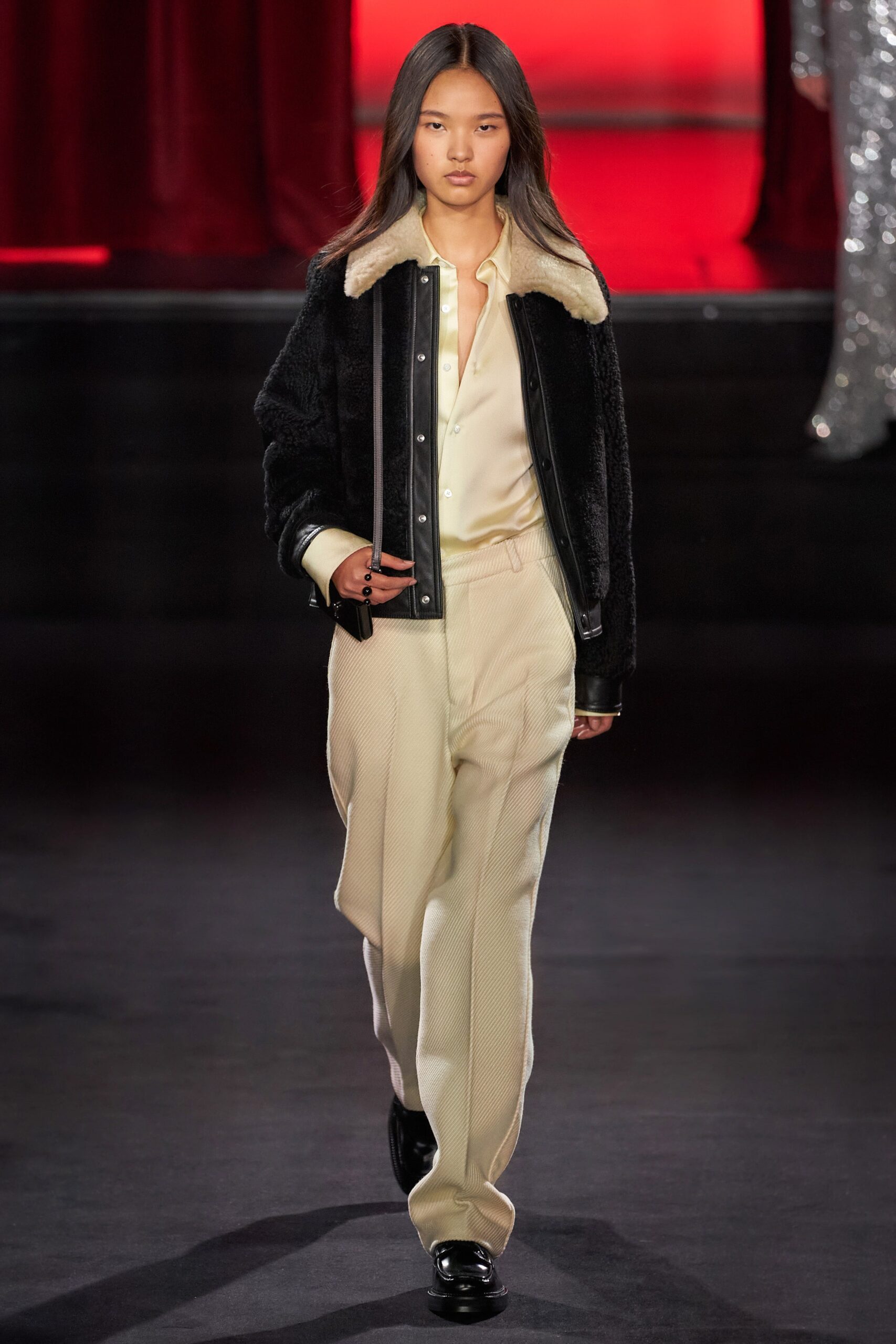 black faux-fur jacket with ivory silk shirt