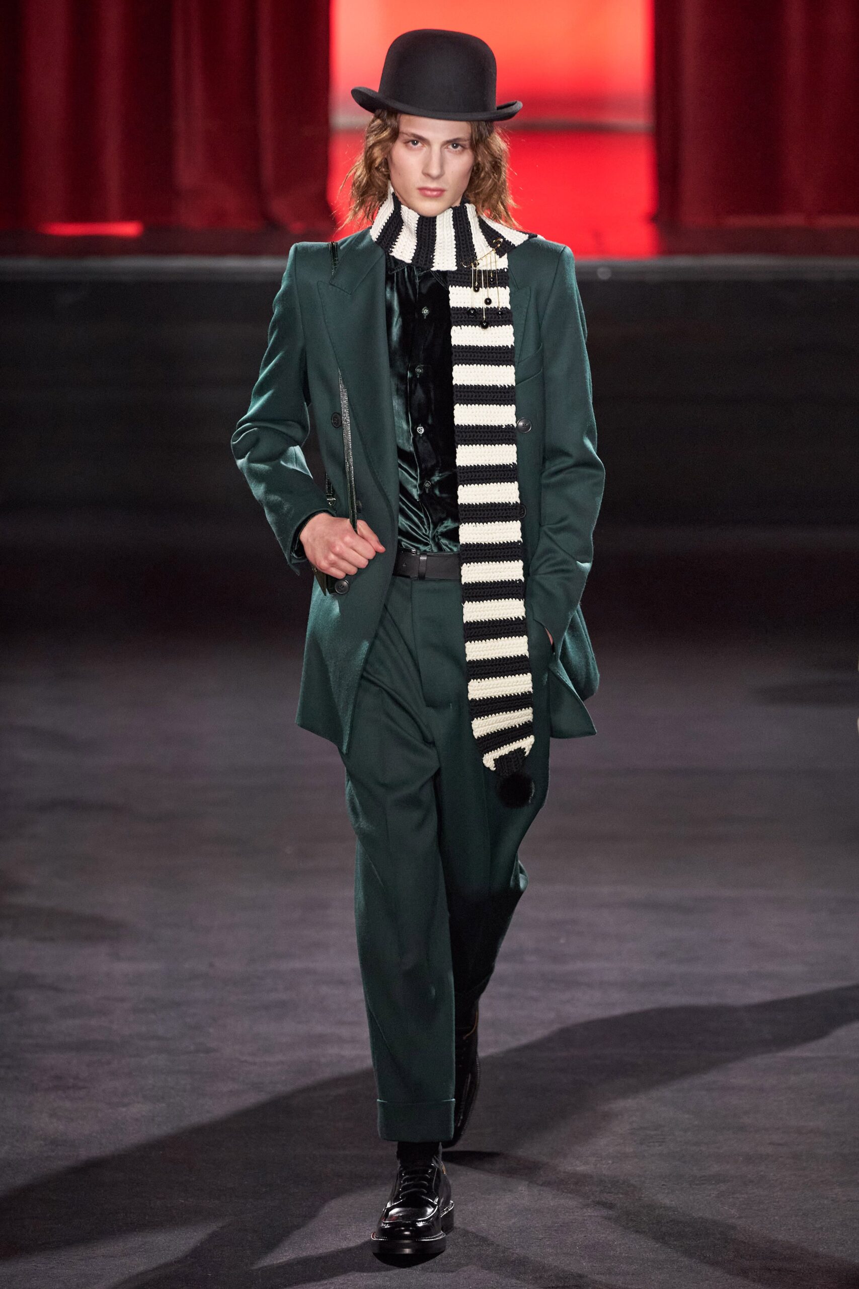 green tailored suit with black shirt