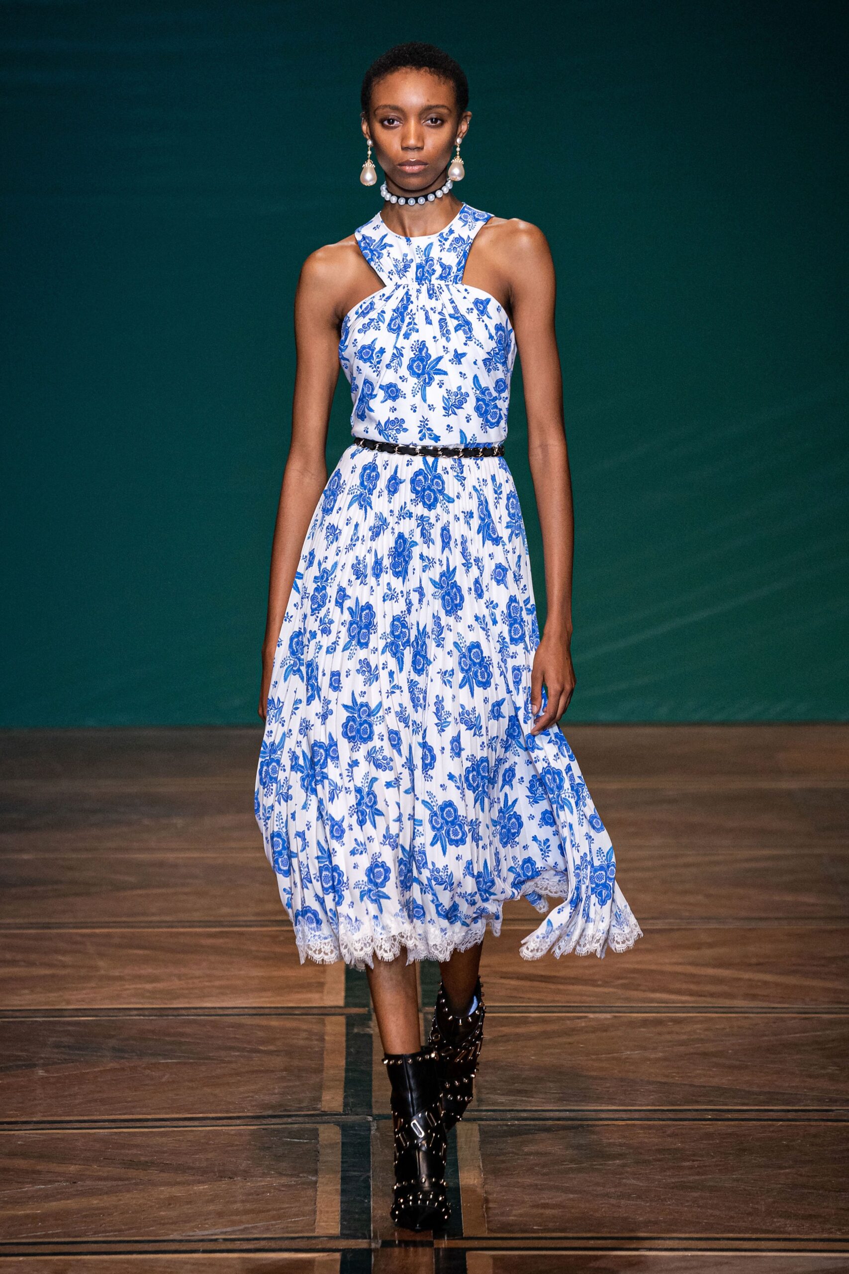 blue and white printed midi dress with black boots