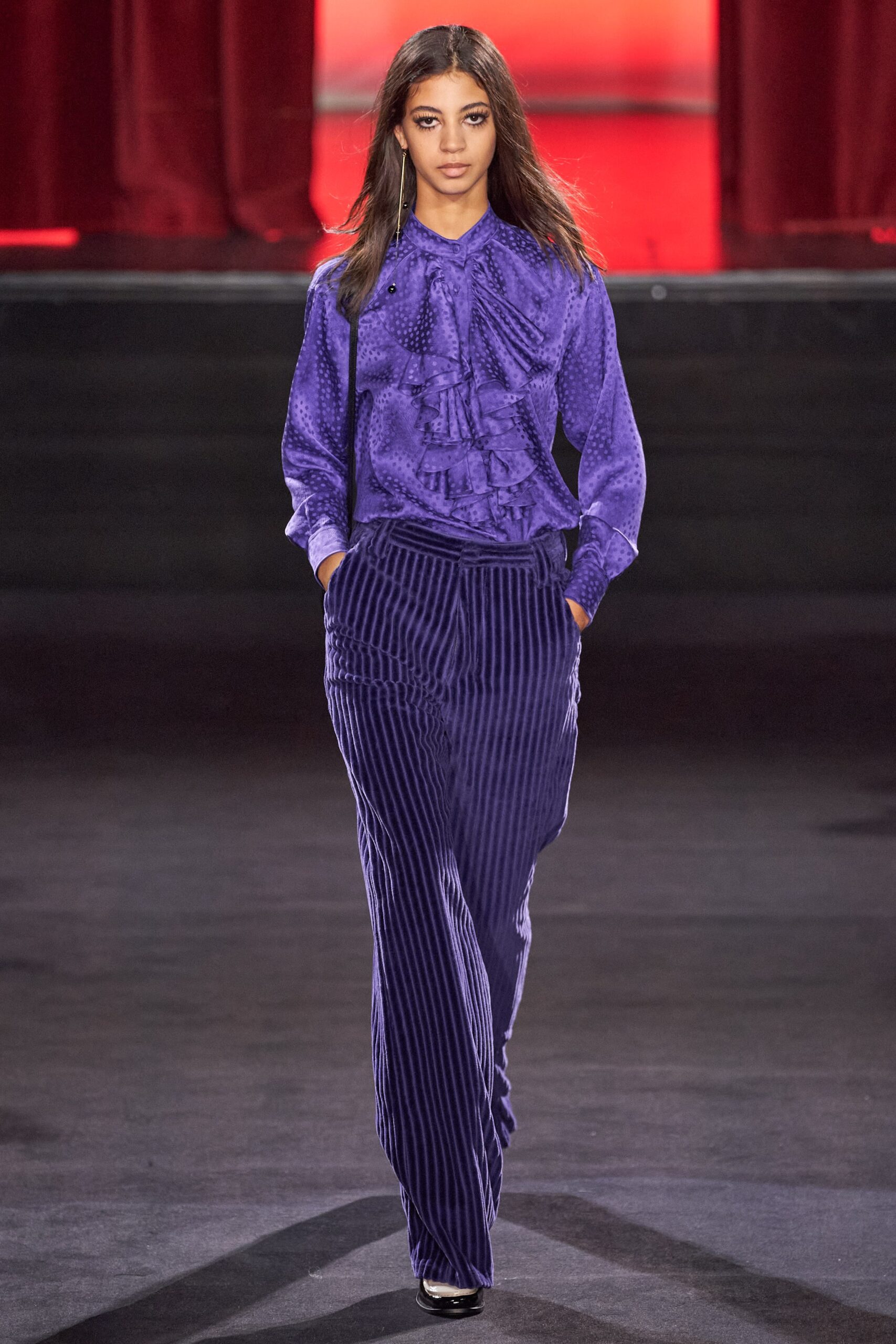 purple silk ruffled blouse and blue striped pants