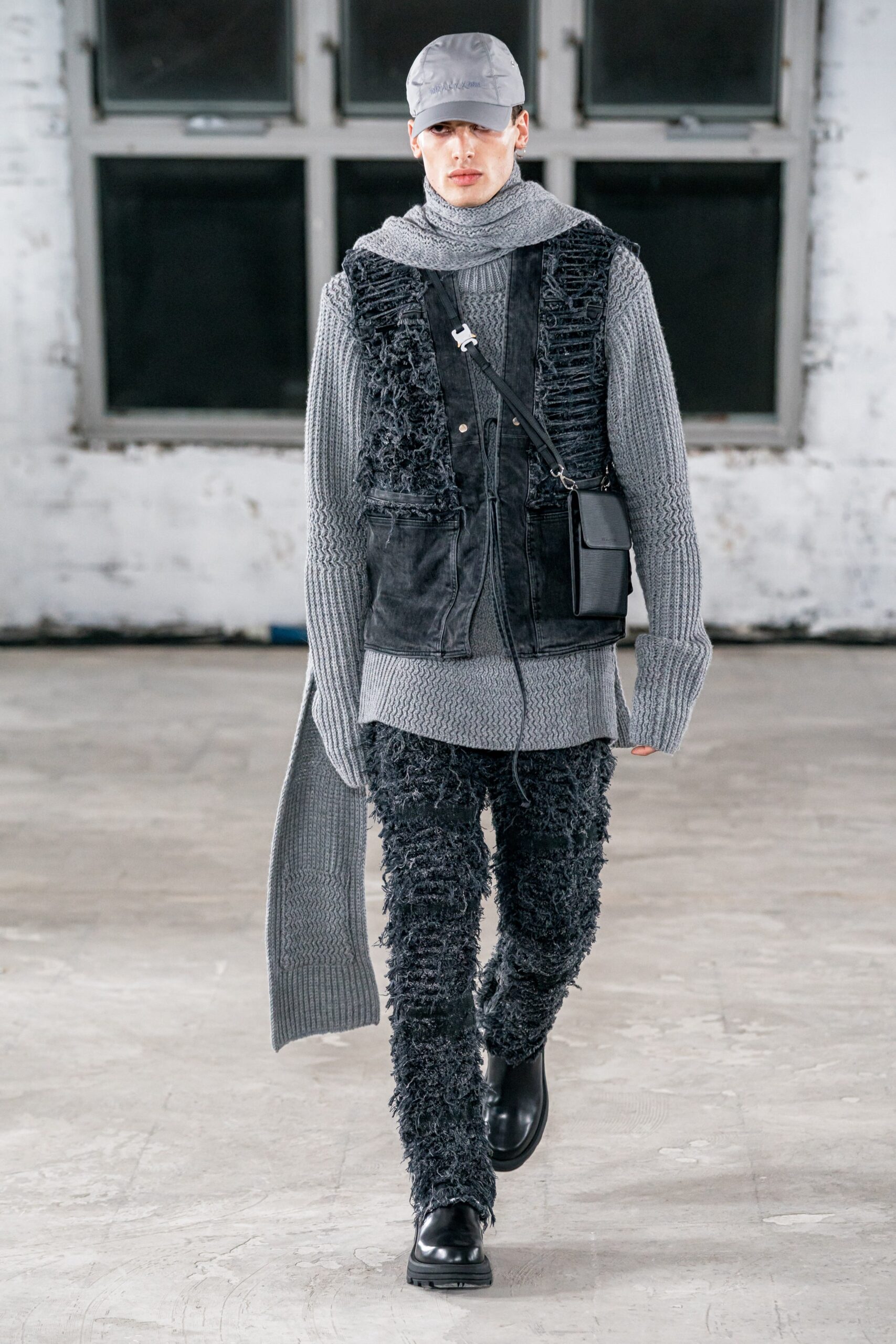 gray sweater black vest and pants