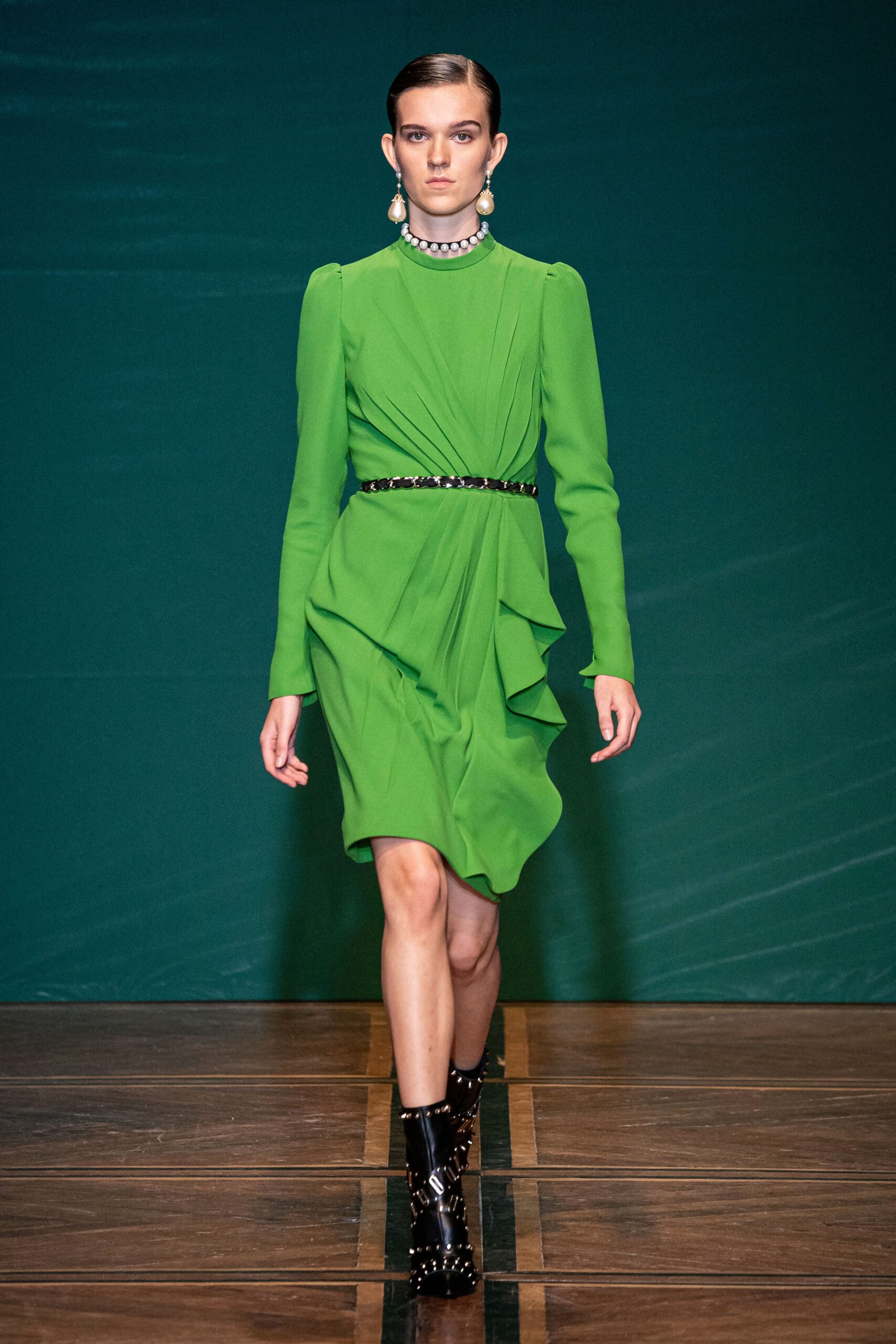 green silk fitted midi dress with black boots