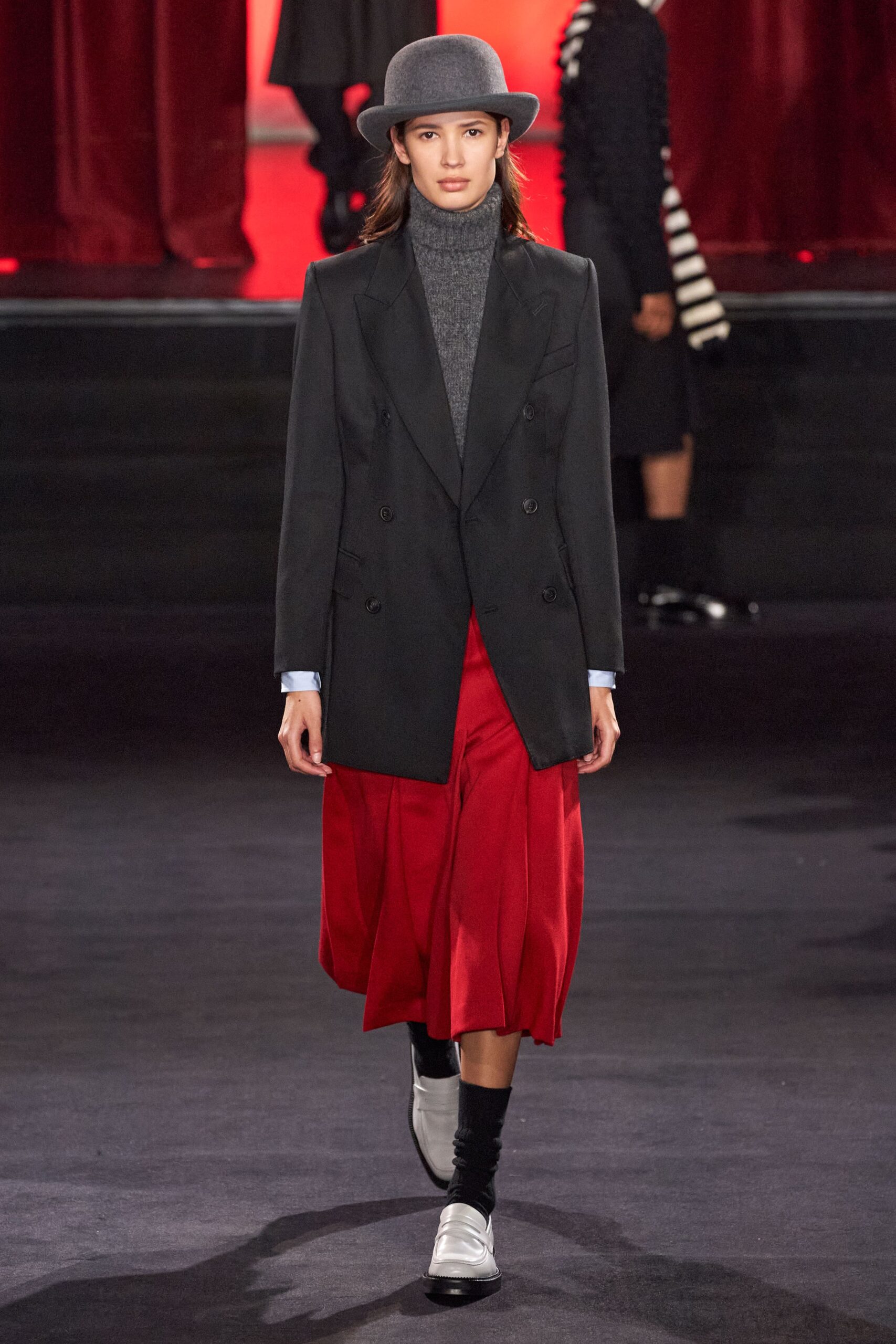 black tailored blazer with red pleated skirt