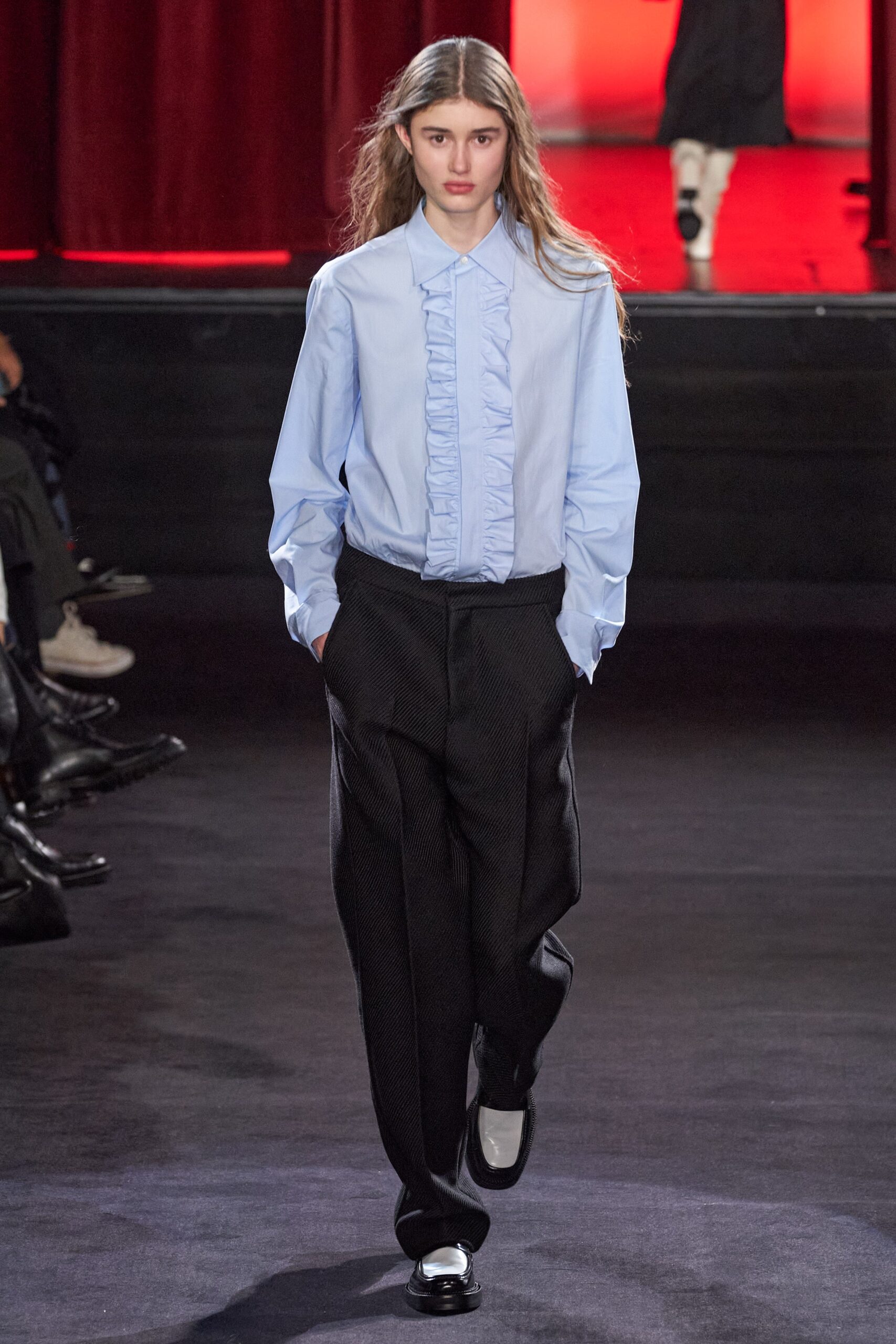 blue ruffled shirt and black tailored pants