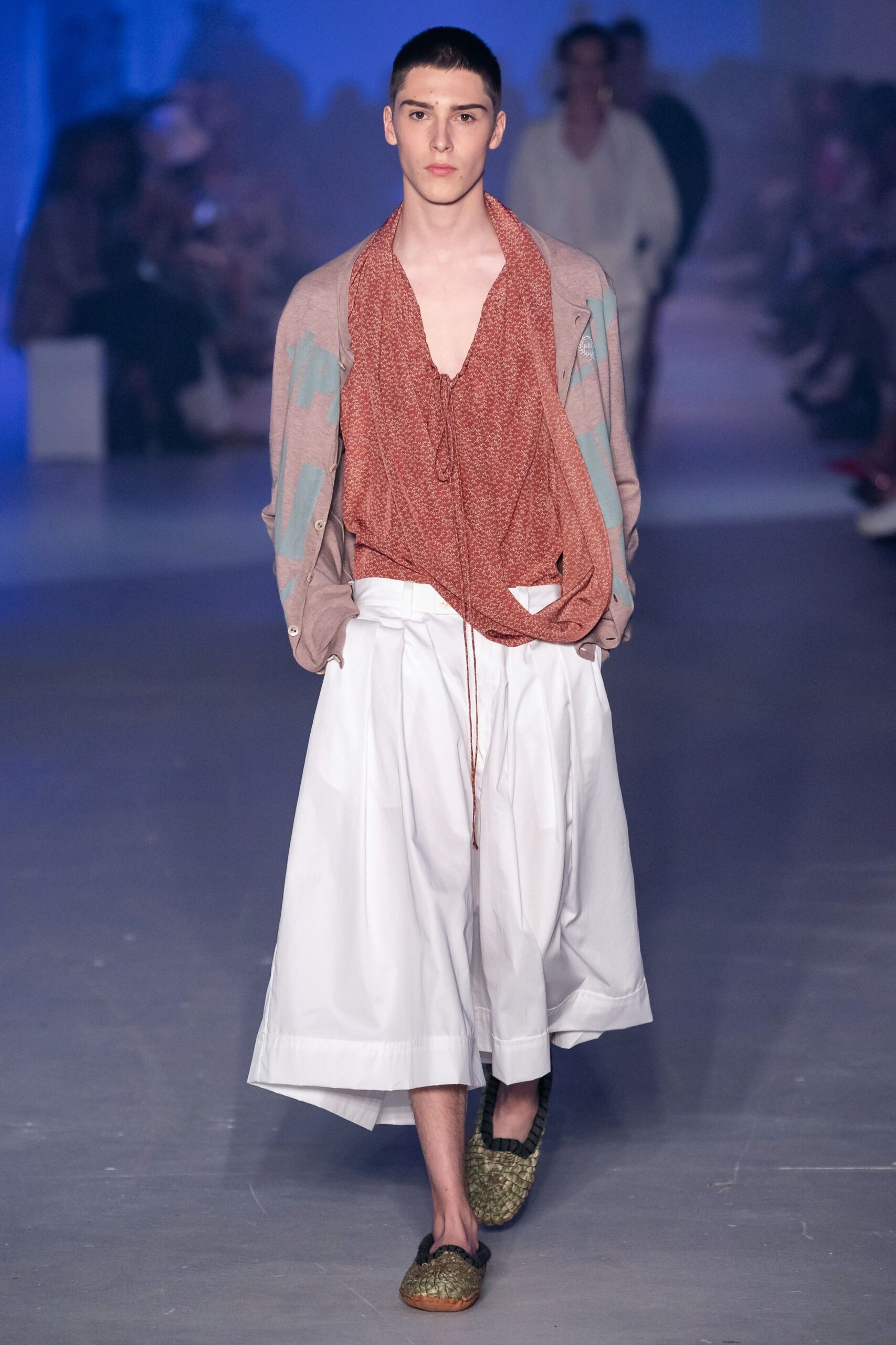 red draped top with white pleated skirt