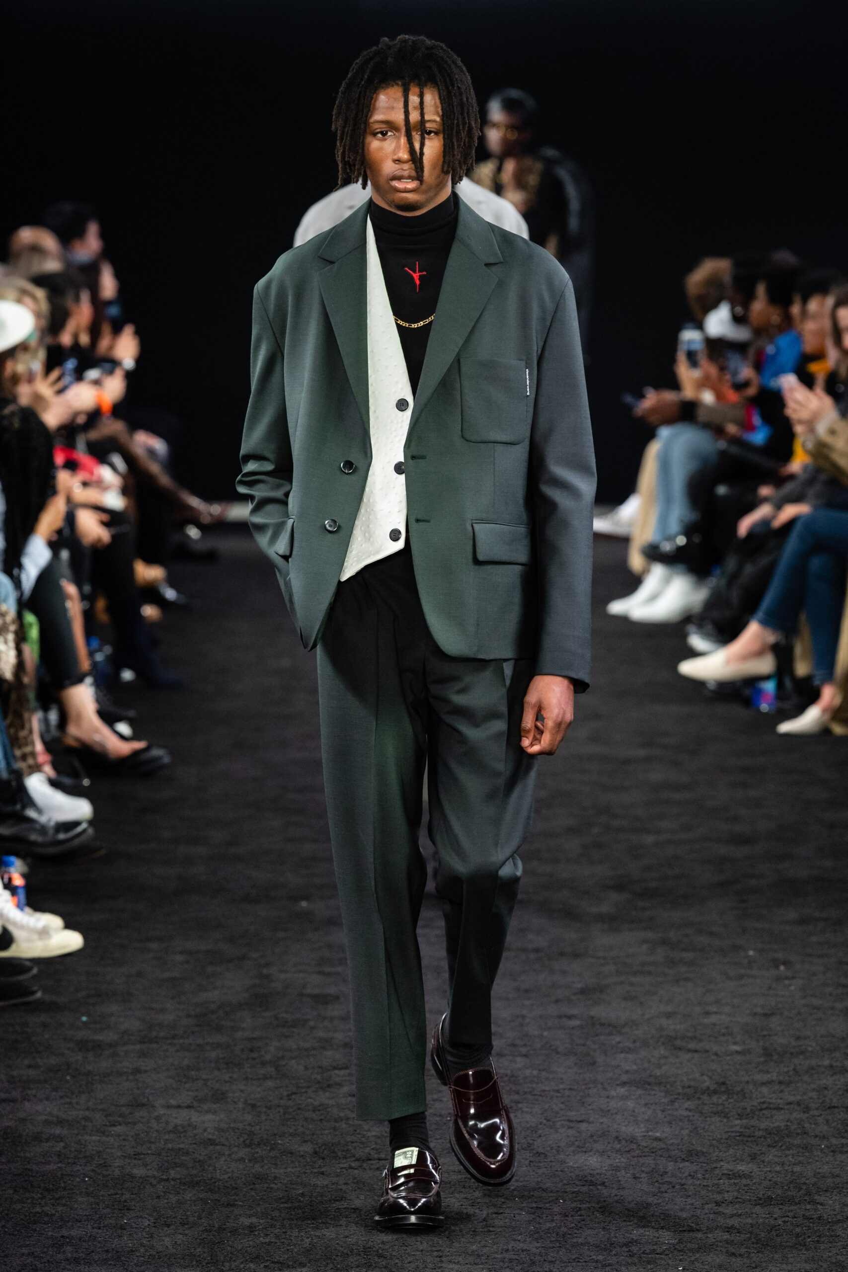 gray tailored suit with black turtleneck