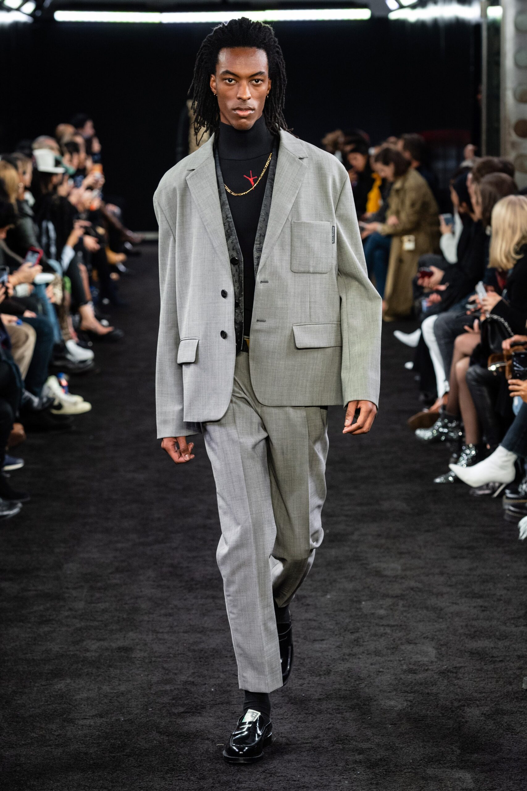gray tailored suit with black shirt