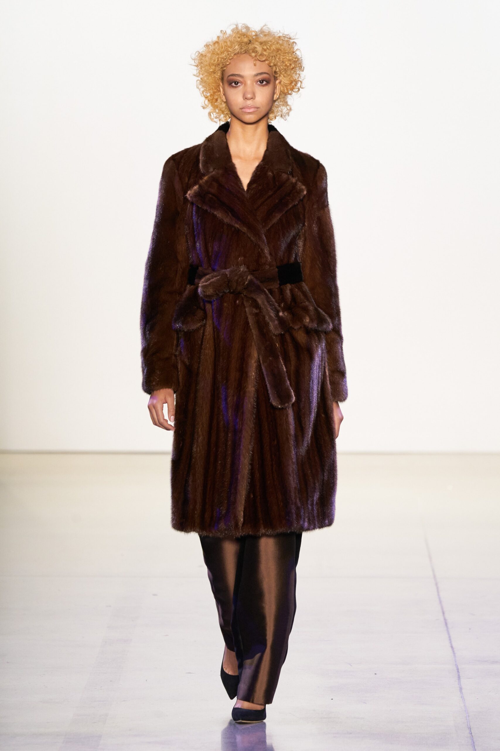 brown faux-fur coat with black pants